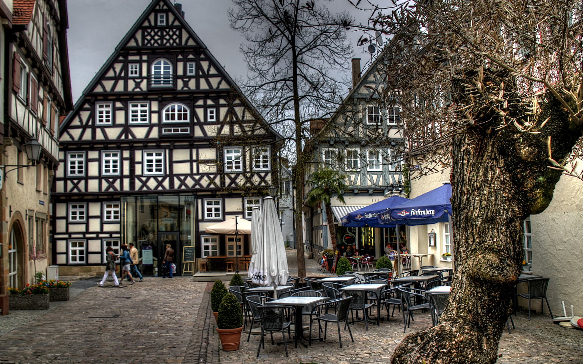 Half-timbered buildings and outdoor cafe in Germany HD Wallpaper