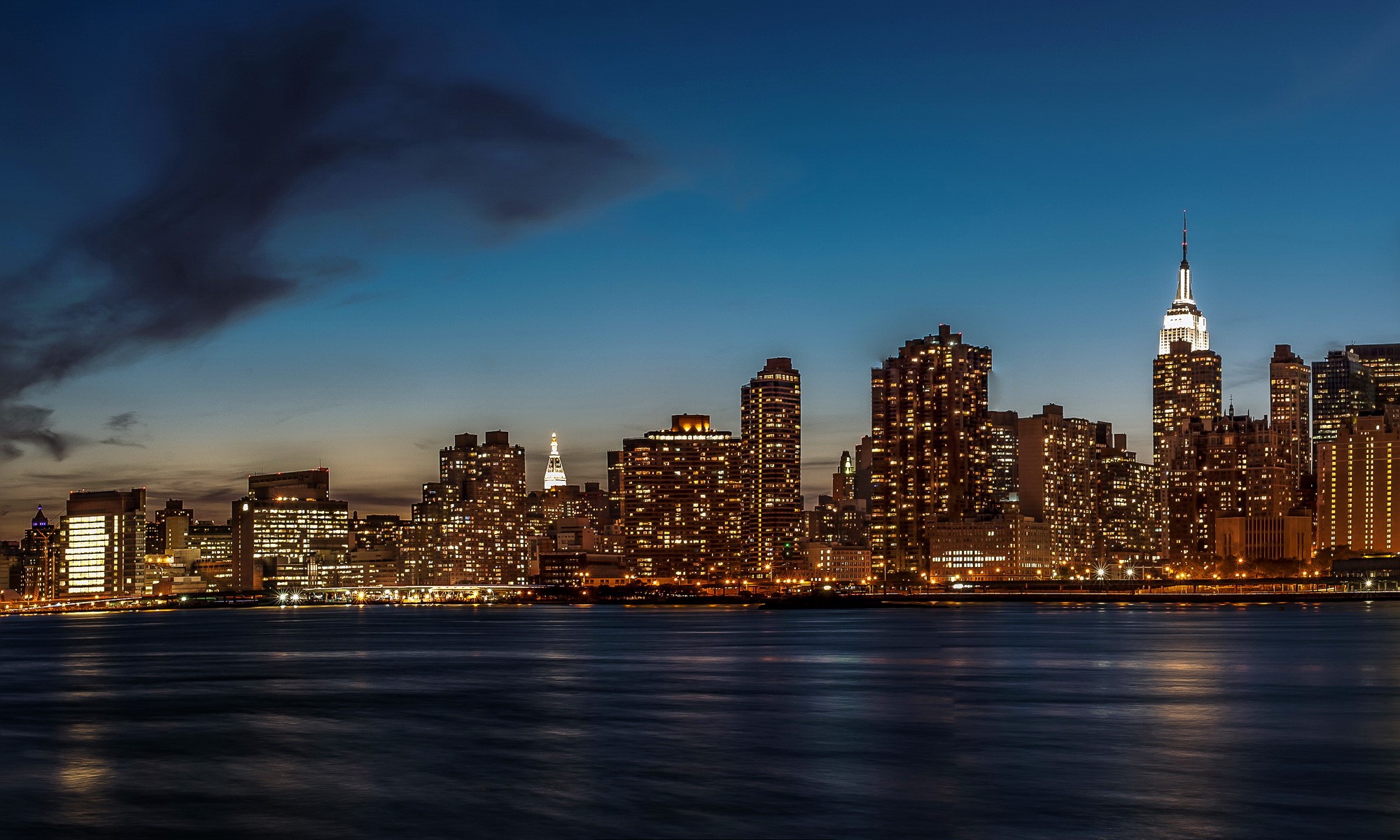 New York City Skyline at Night Over Water HD Wallpaper