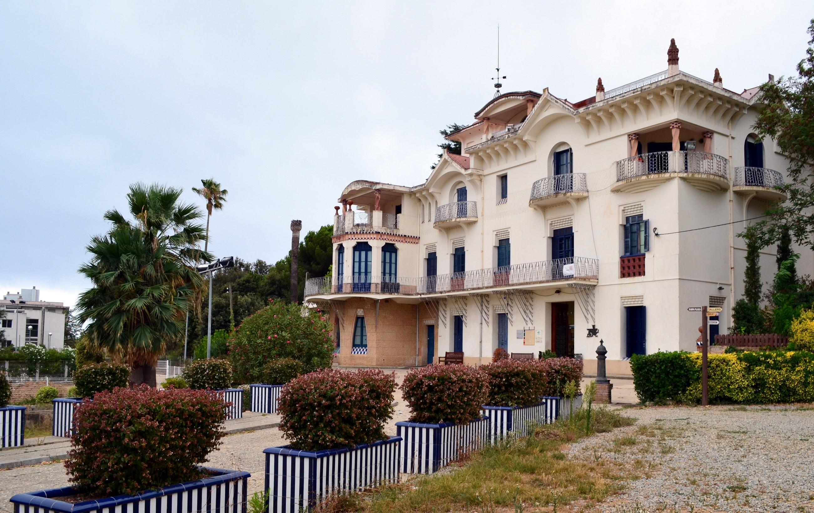 White building with balconies and palm trees in Spain HD Wallpaper