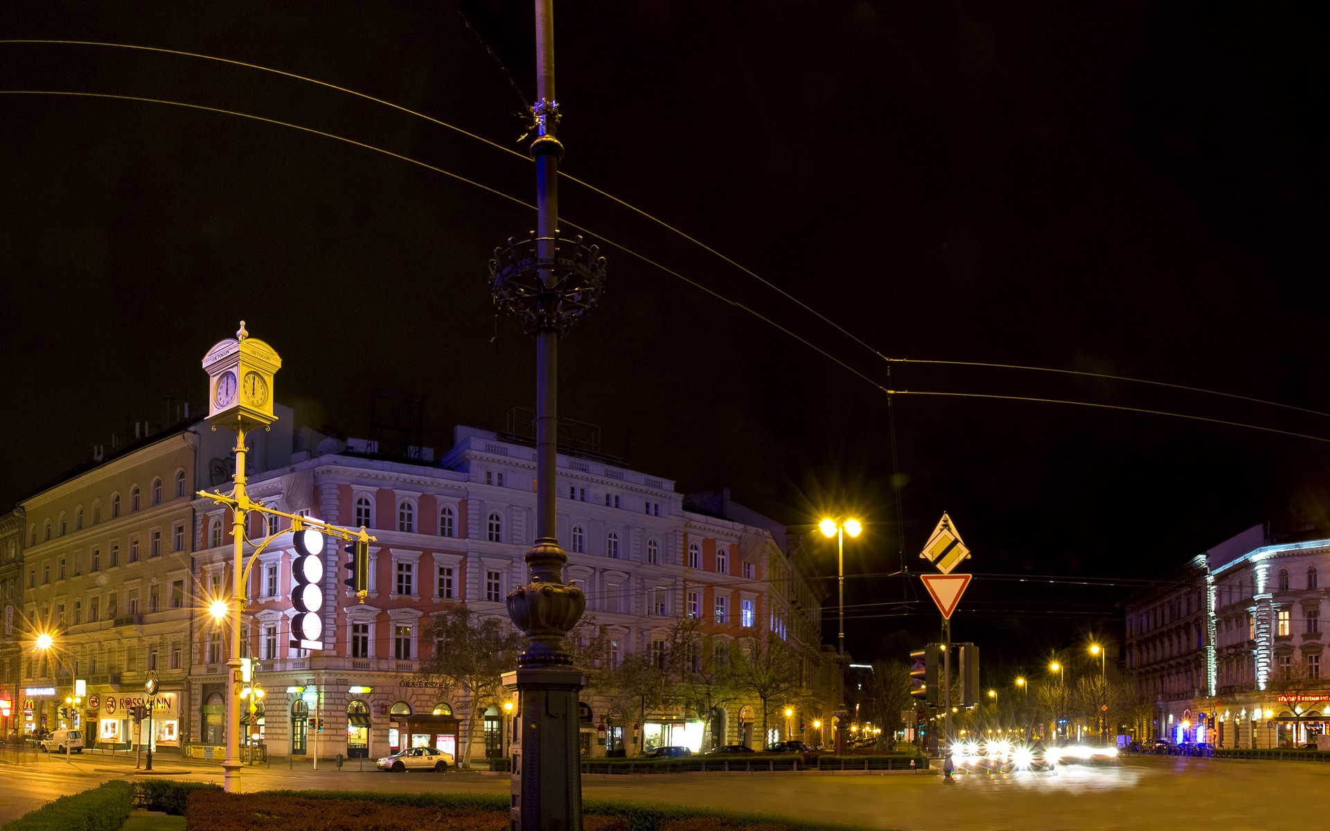 Night street scene in Hungary with buildings and traffic lights HD Wallpaper