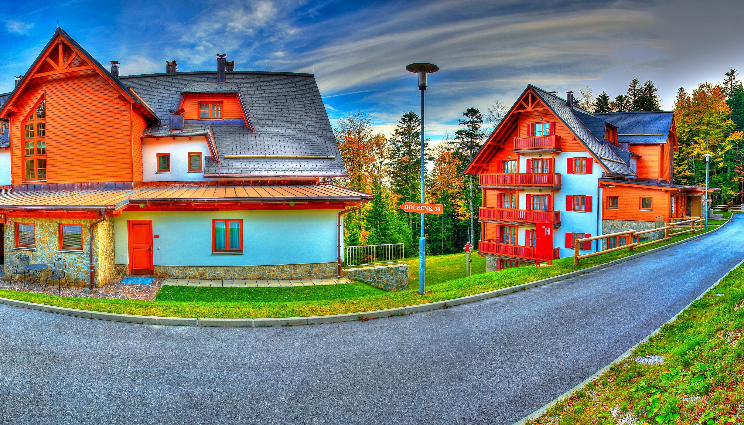 Orange and white buildings on a road in Slovenia HD Wallpaper