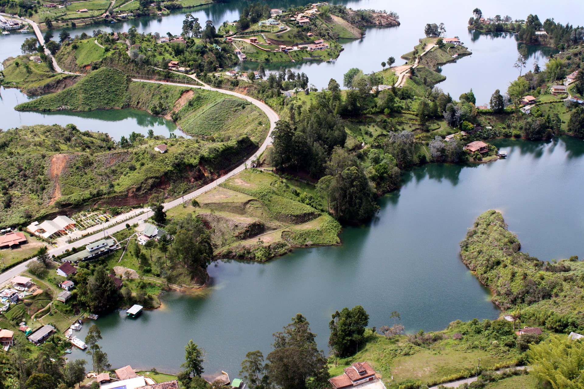 Aerial view of a lake with islands and roads HD Wallpaper