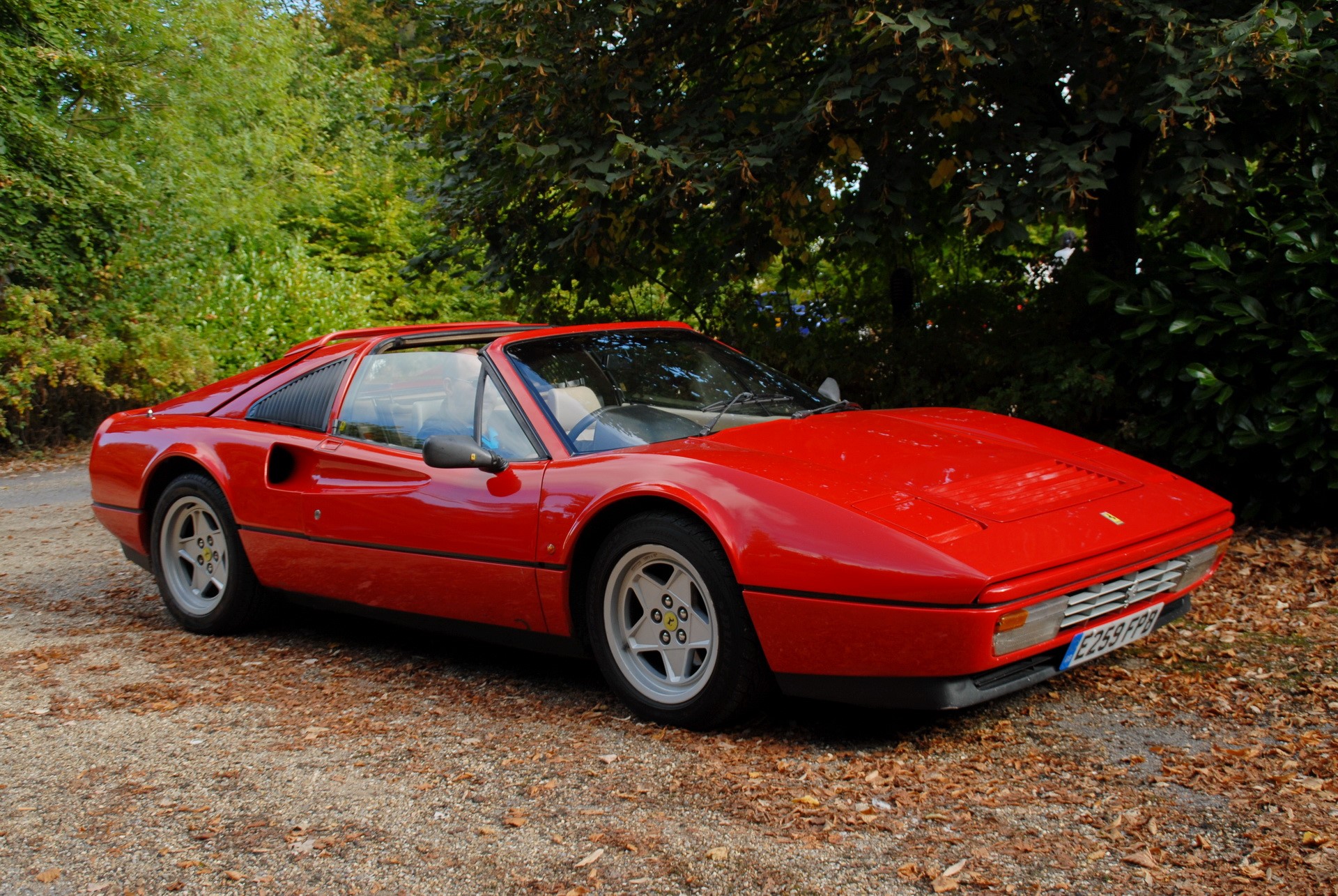 Red Ferrari 308 GTS parked on gravel road HD Wallpaper