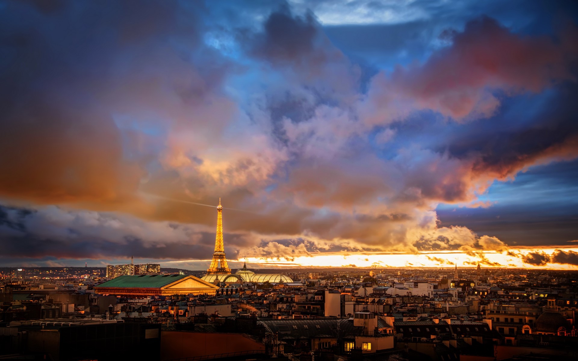 Eiffel Tower and Paris skyline at sunset with dramatic clouds HD Wallpaper