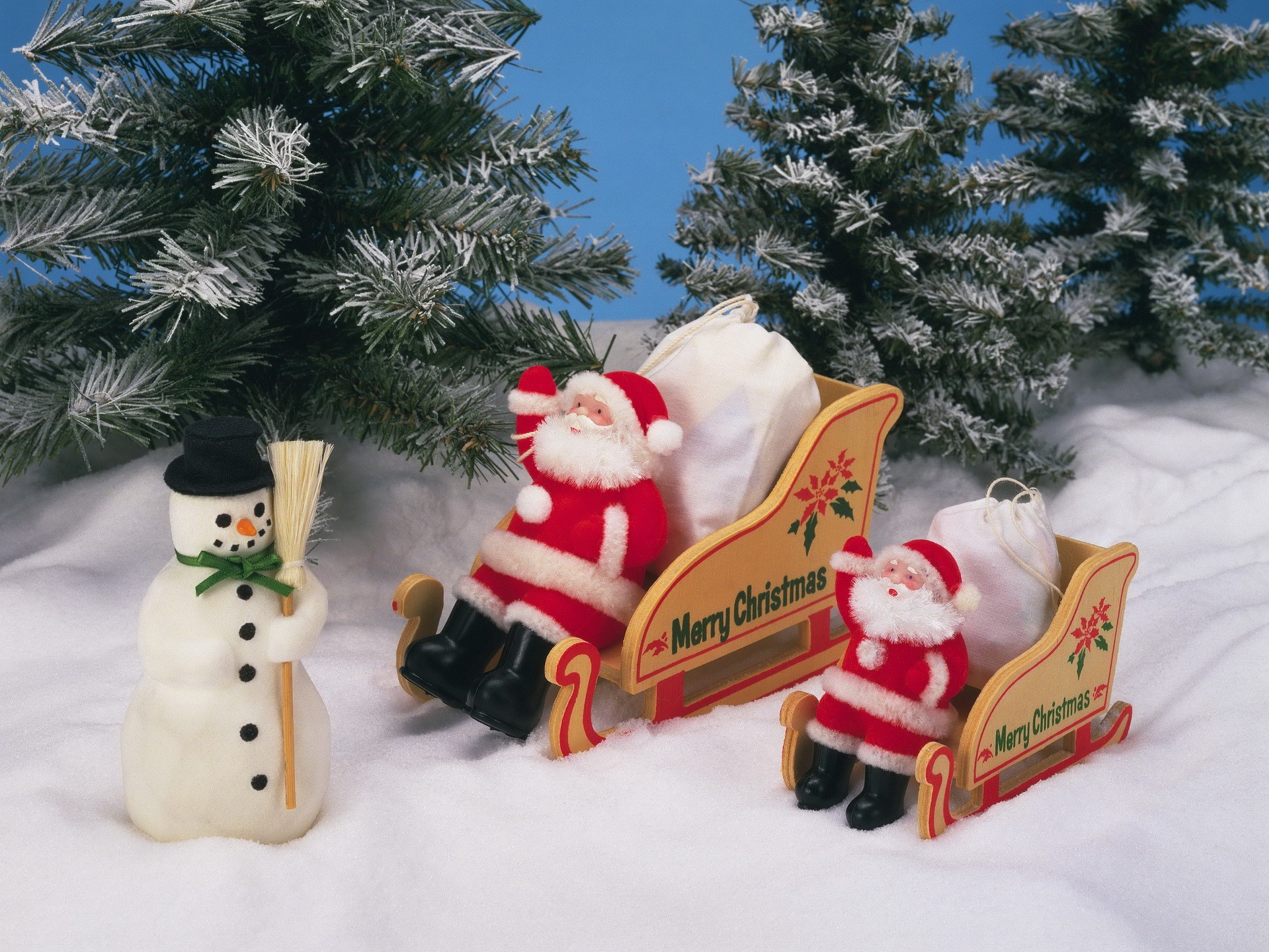 Christmas scene with Santa Claus, snowman, and sleds HD Wallpaper