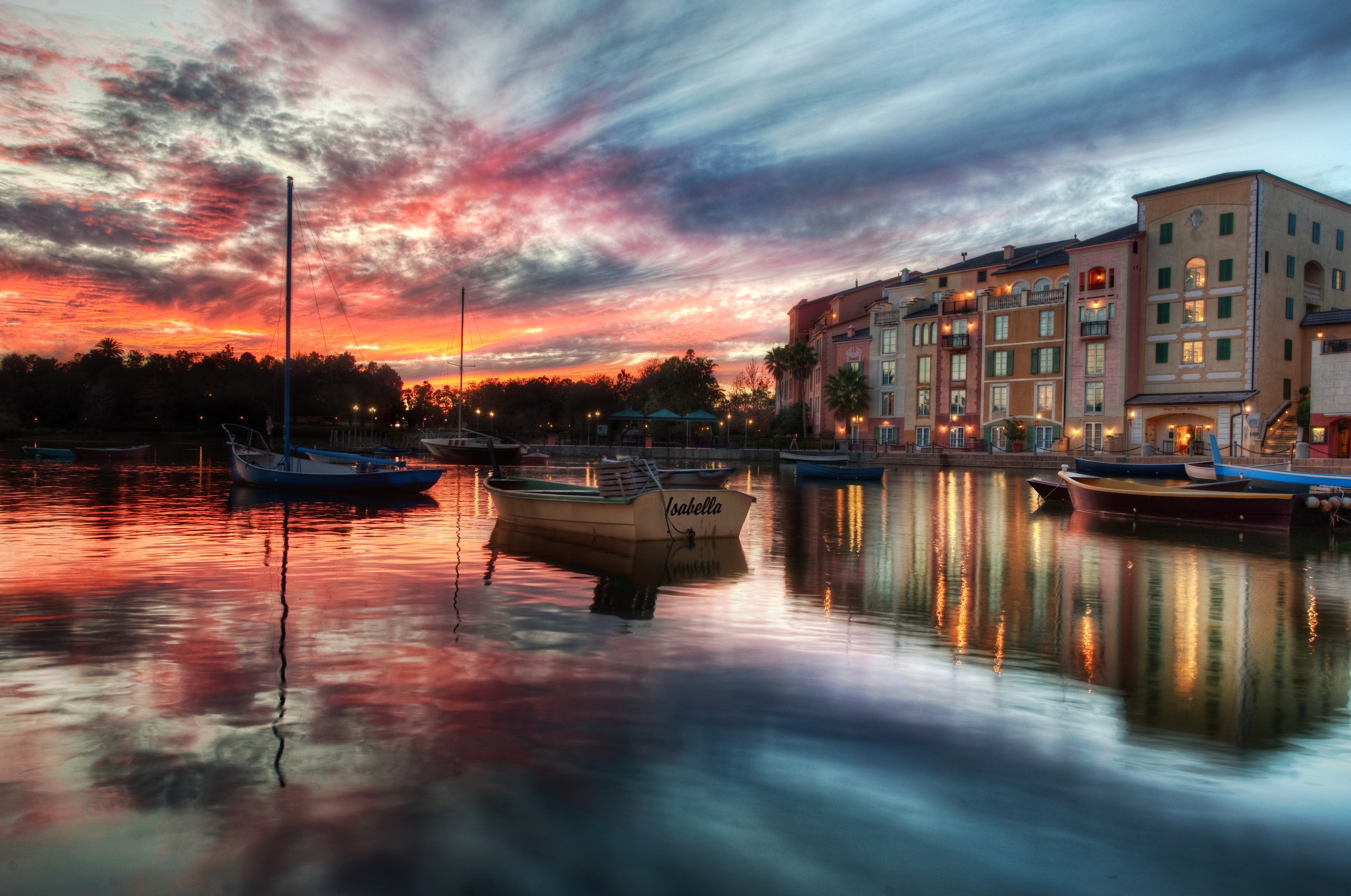 Boats on a canal at sunset with colorful clouds HD Wallpaper