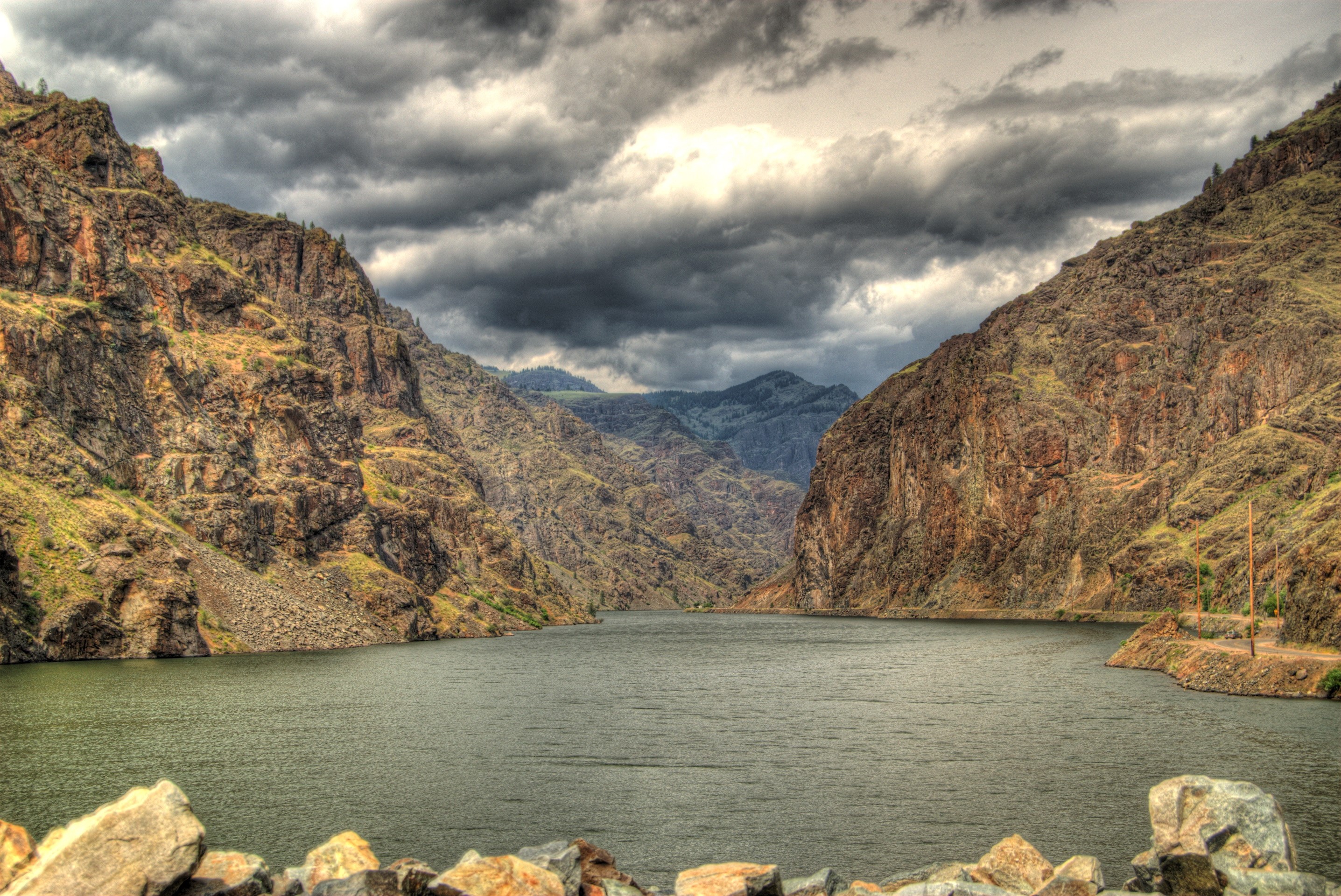 River flowing through mountains under cloudy sky in USA HD Wallpaper