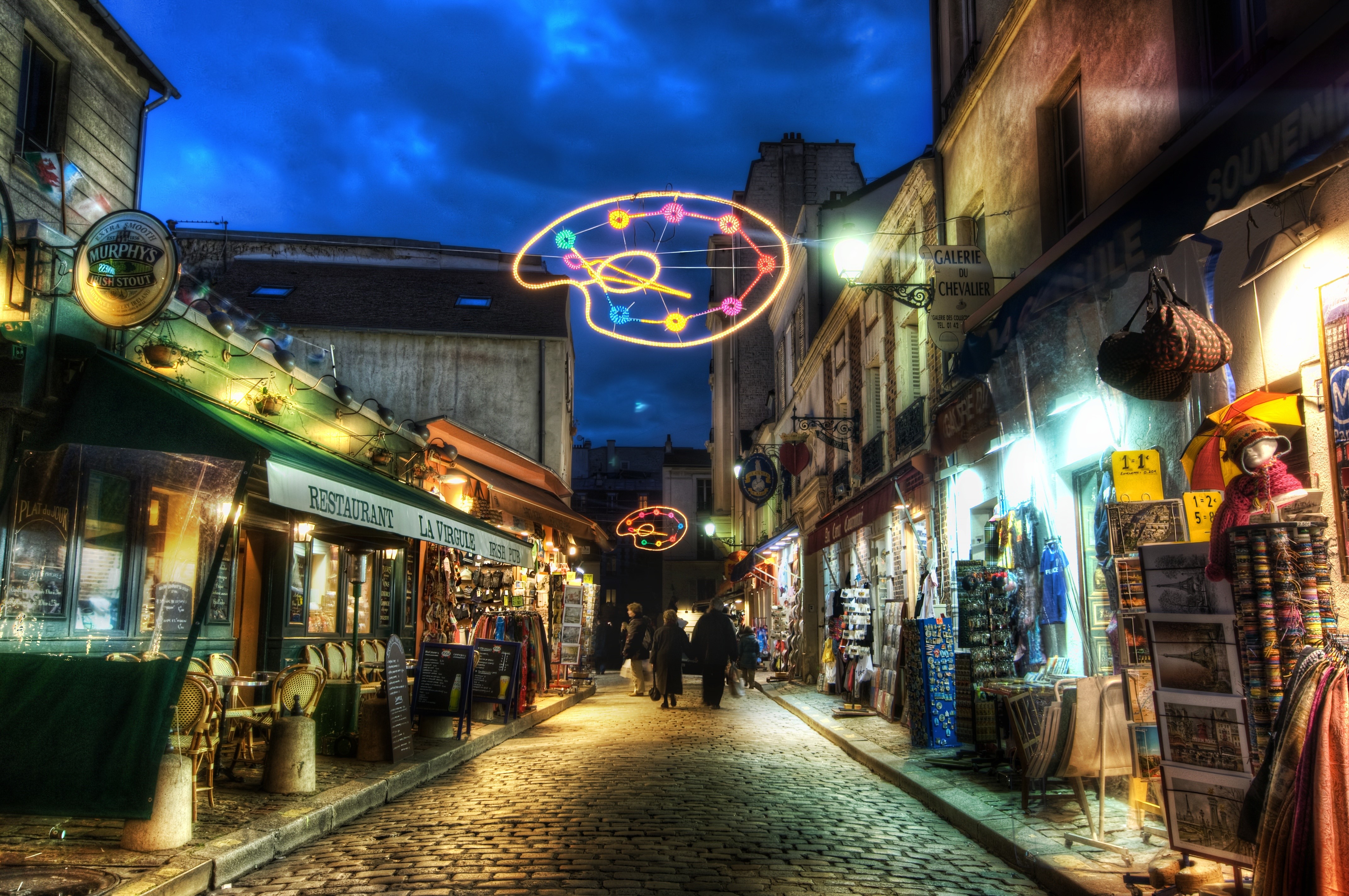 Paris street with artist palette lights at night HD Wallpaper