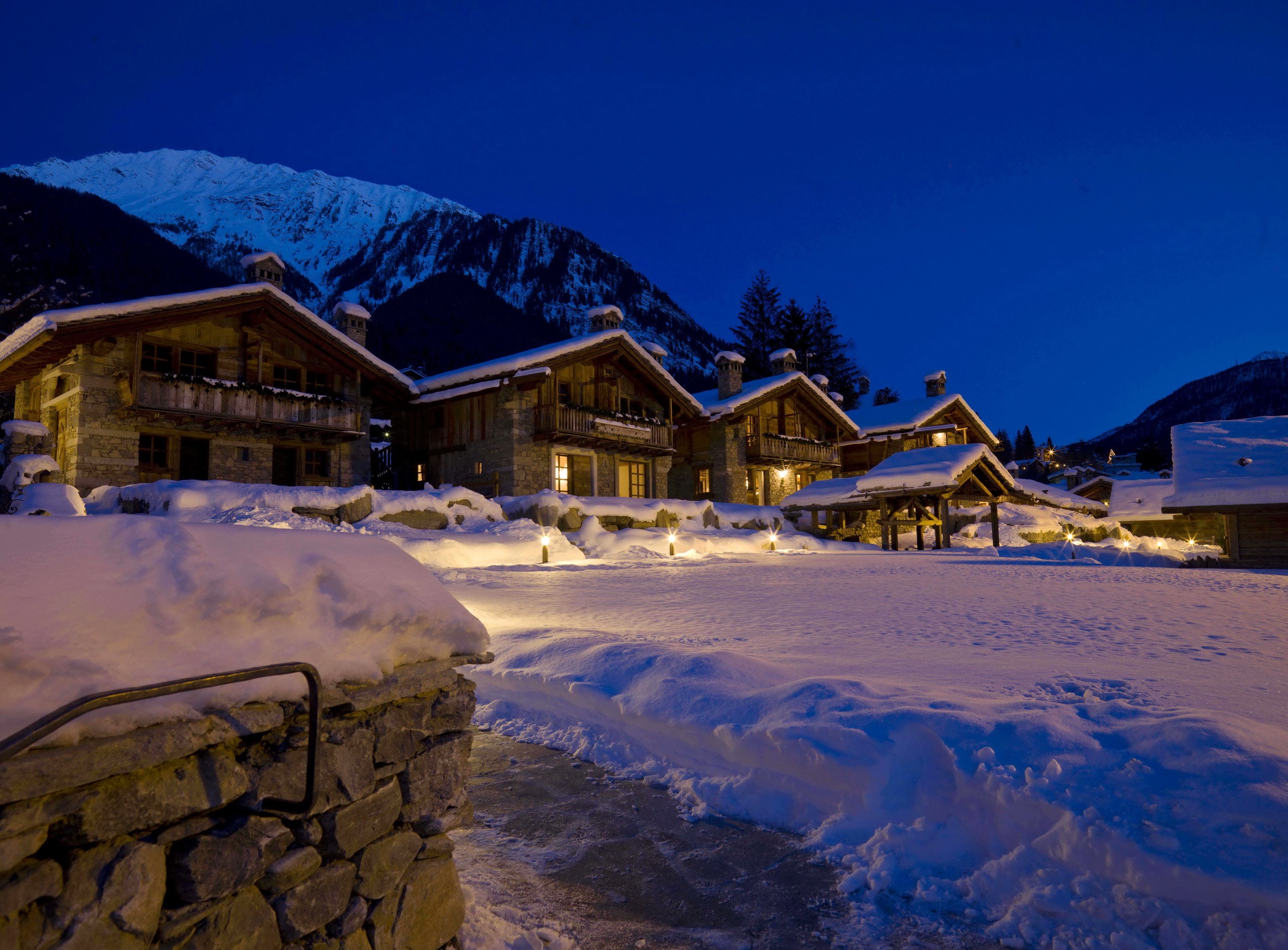 Snowy mountain village at dusk HD Wallpaper