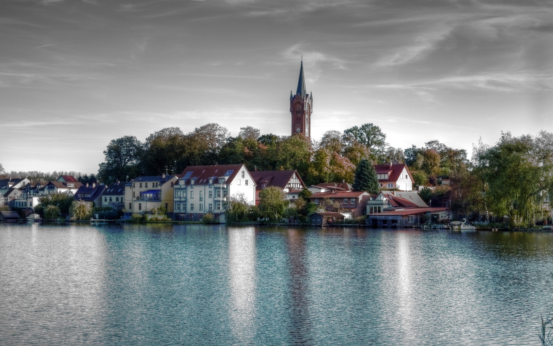 Houses and church tower by a lake in Germany HD Wallpaper