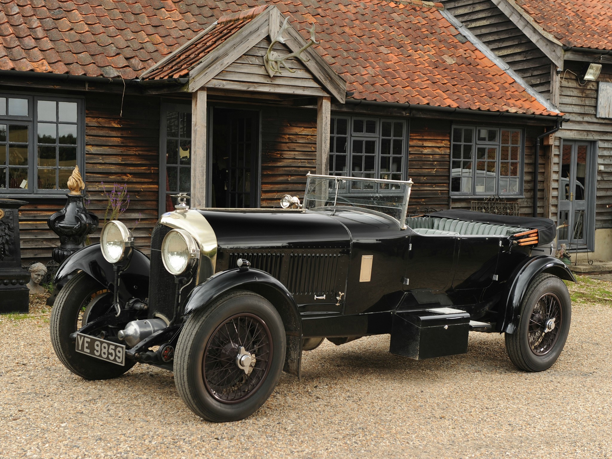 Black Bentley YE 9859 parked in front of wooden building HD Wallpaper