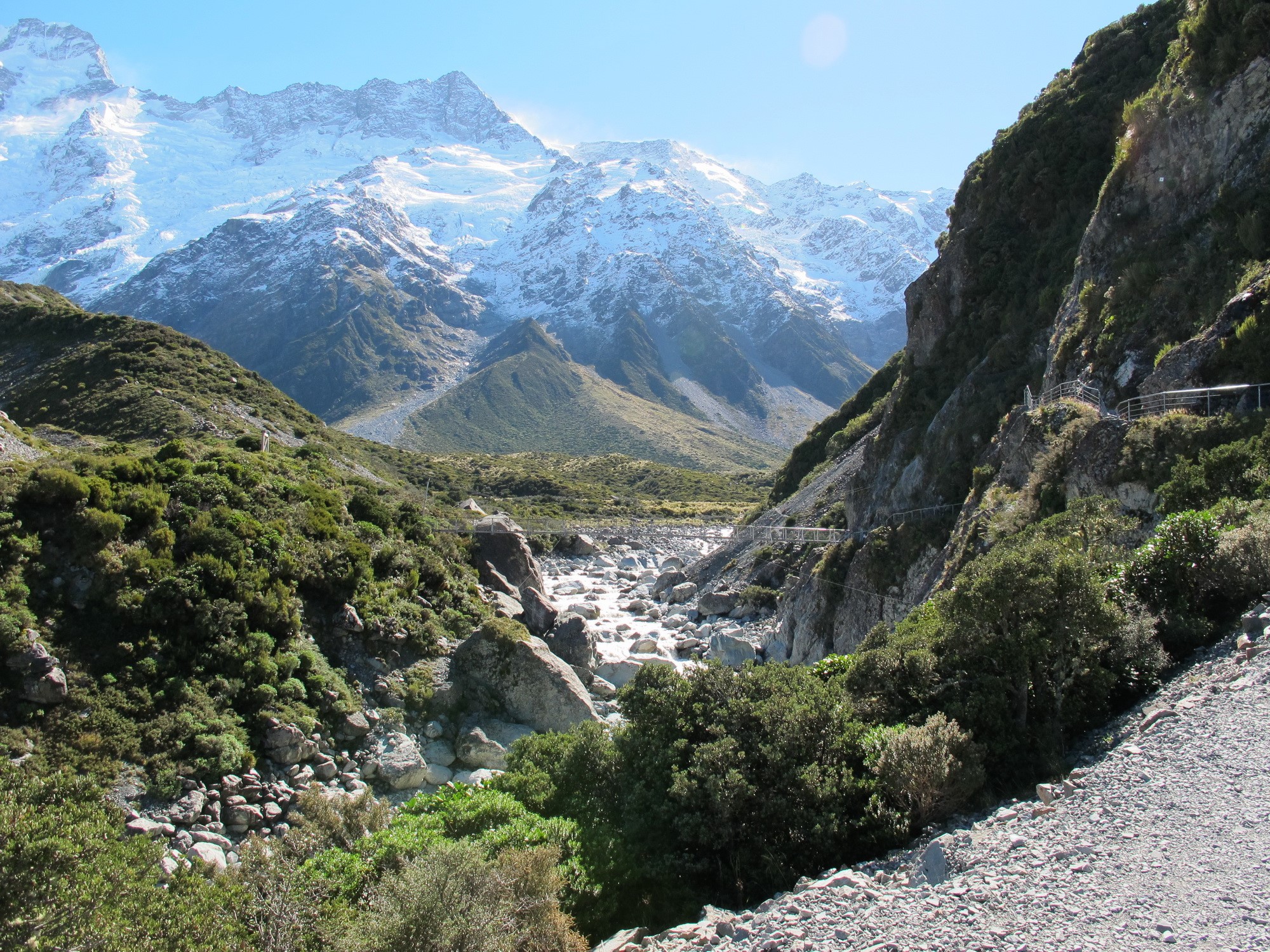 Snow-capped mountains and a rocky river valley in New Zealand HD Wallpaper