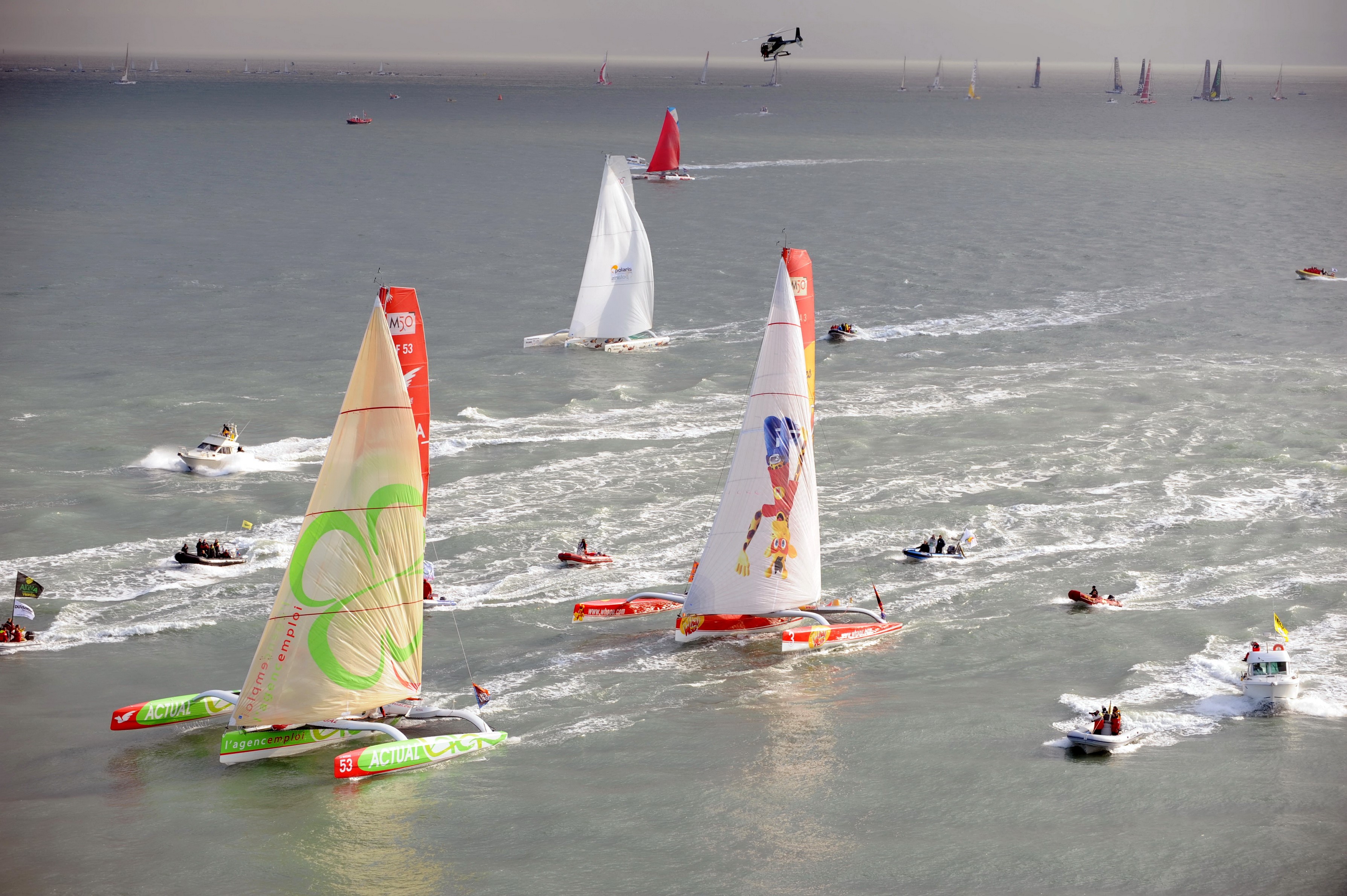 Sailboats racing in the ocean with a helicopter overhead HD Wallpaper