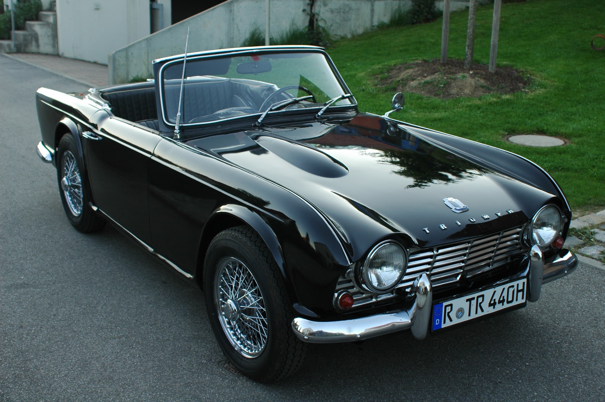 Black Triumph TR3A convertible parked on a street HD Wallpaper