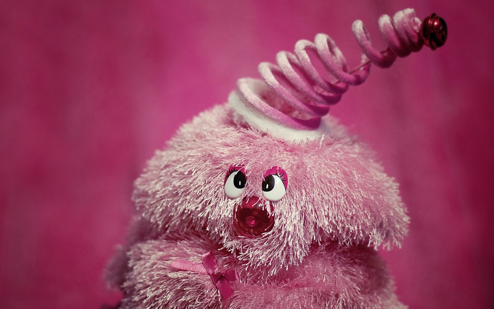 Pink fuzzy toy with spring and bell HD Wallpaper
