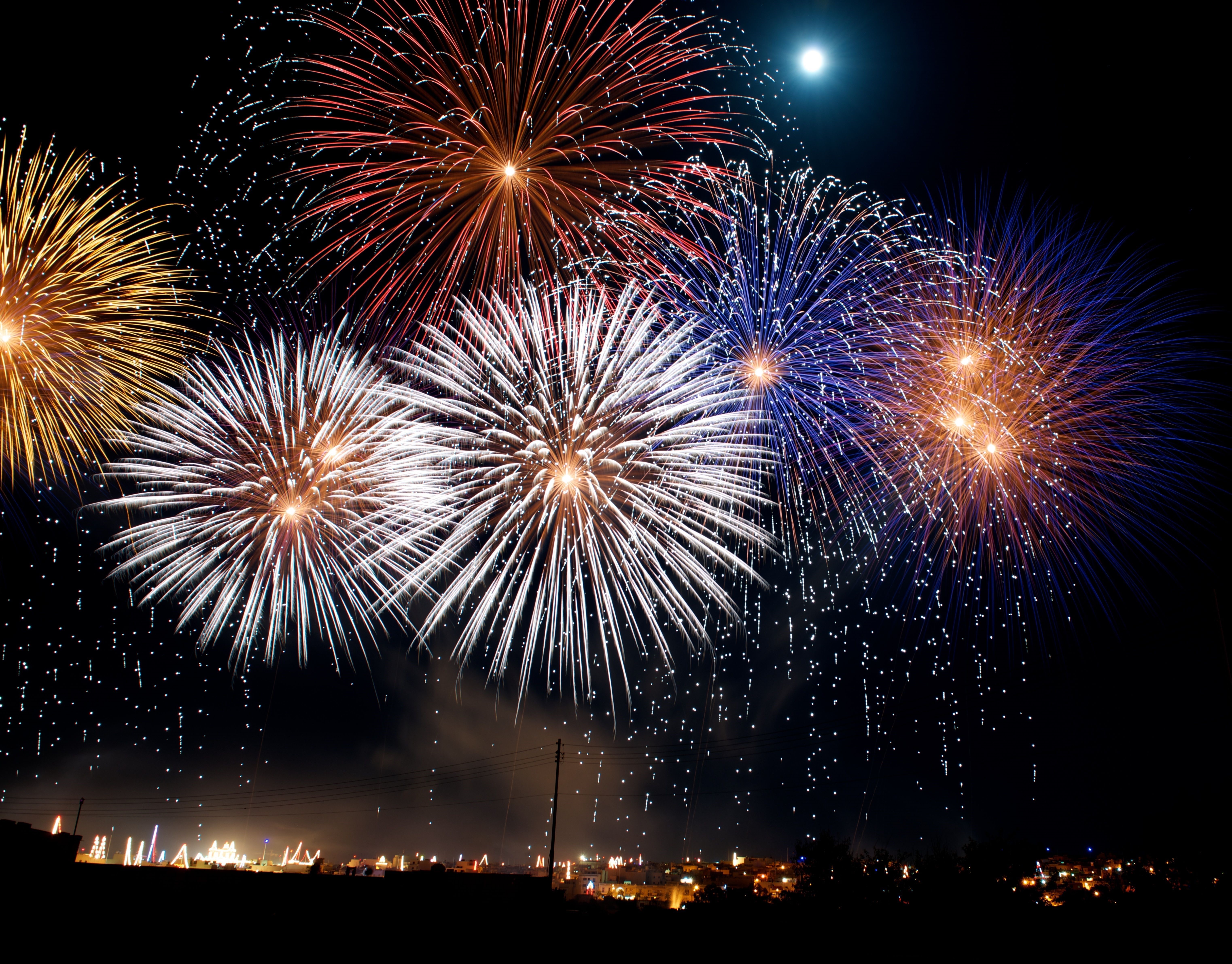 Fireworks Display Over Town at Night HD Wallpaper