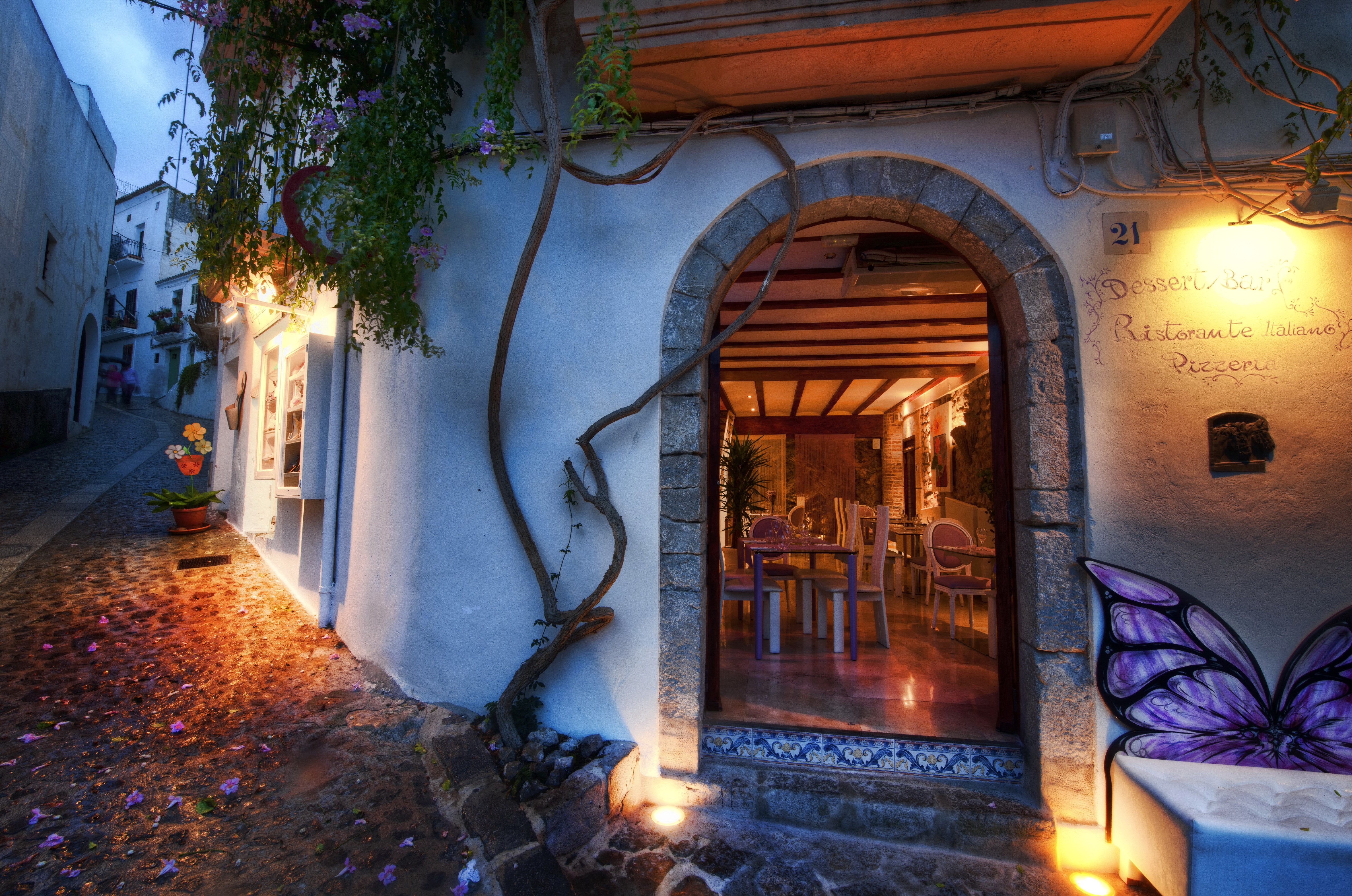 Restaurant entrance on a cobblestone street in Spain HD Wallpaper