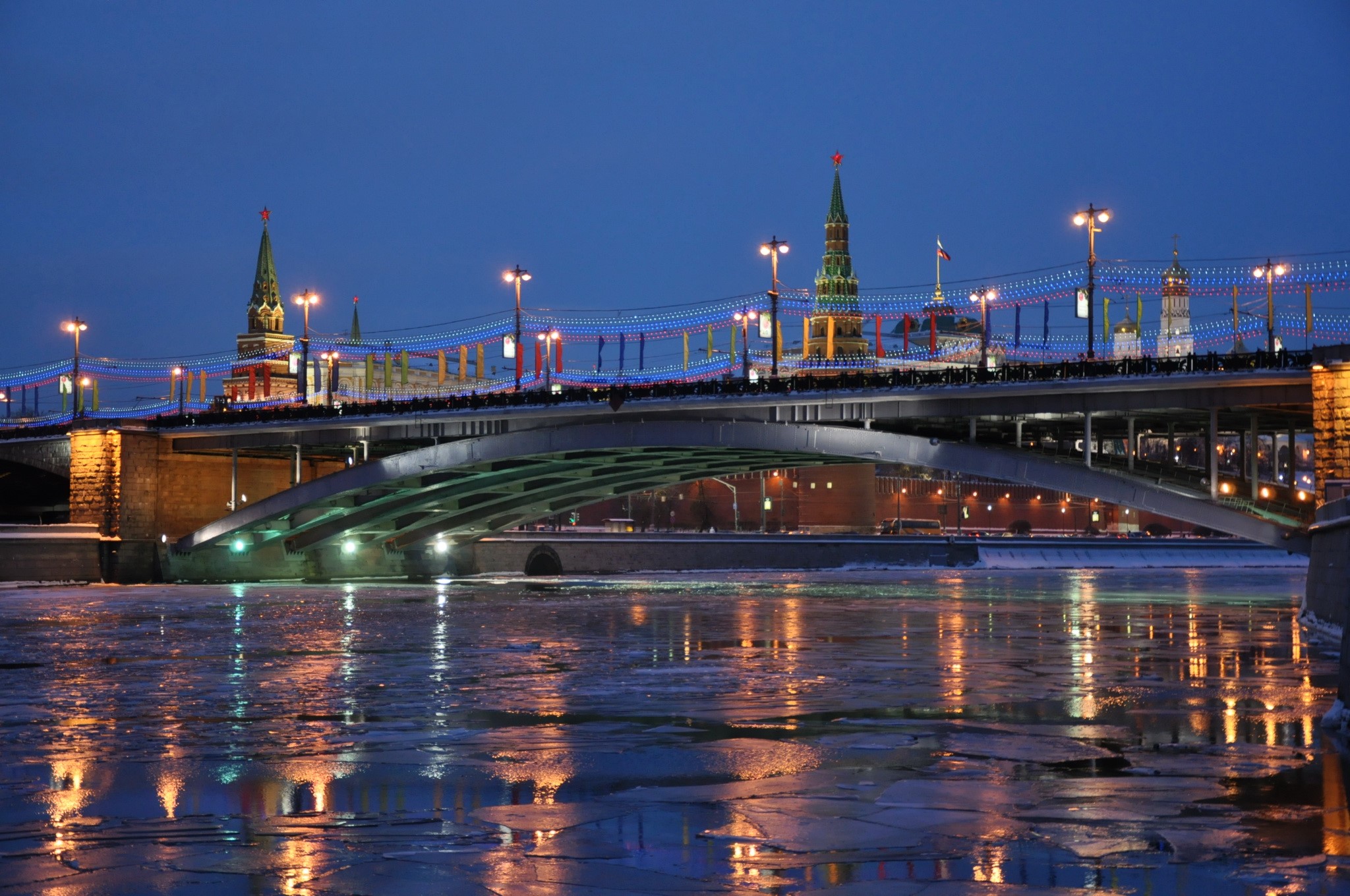 Bridge over frozen river at night with Kremlin towers HD Wallpaper