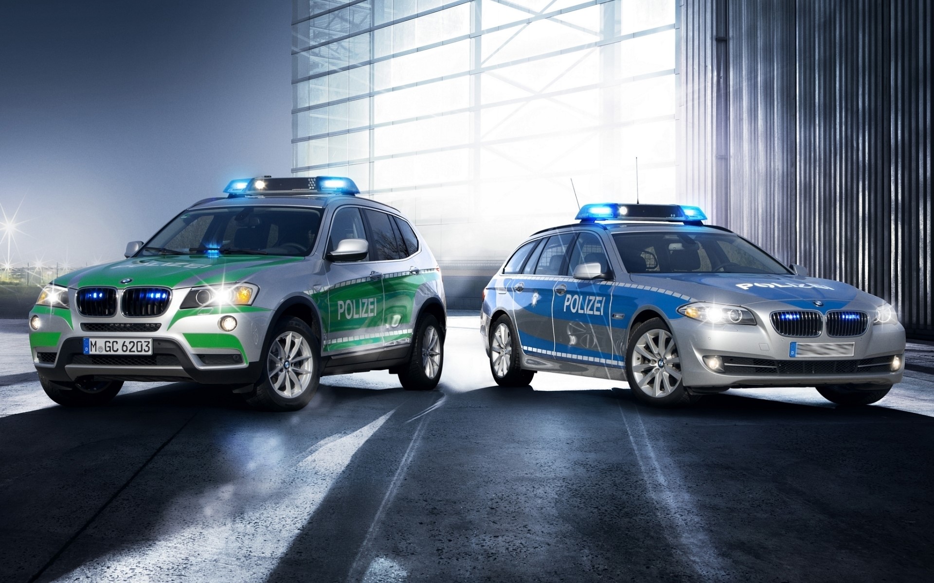 Two BMW police cars with lights on HD Wallpaper