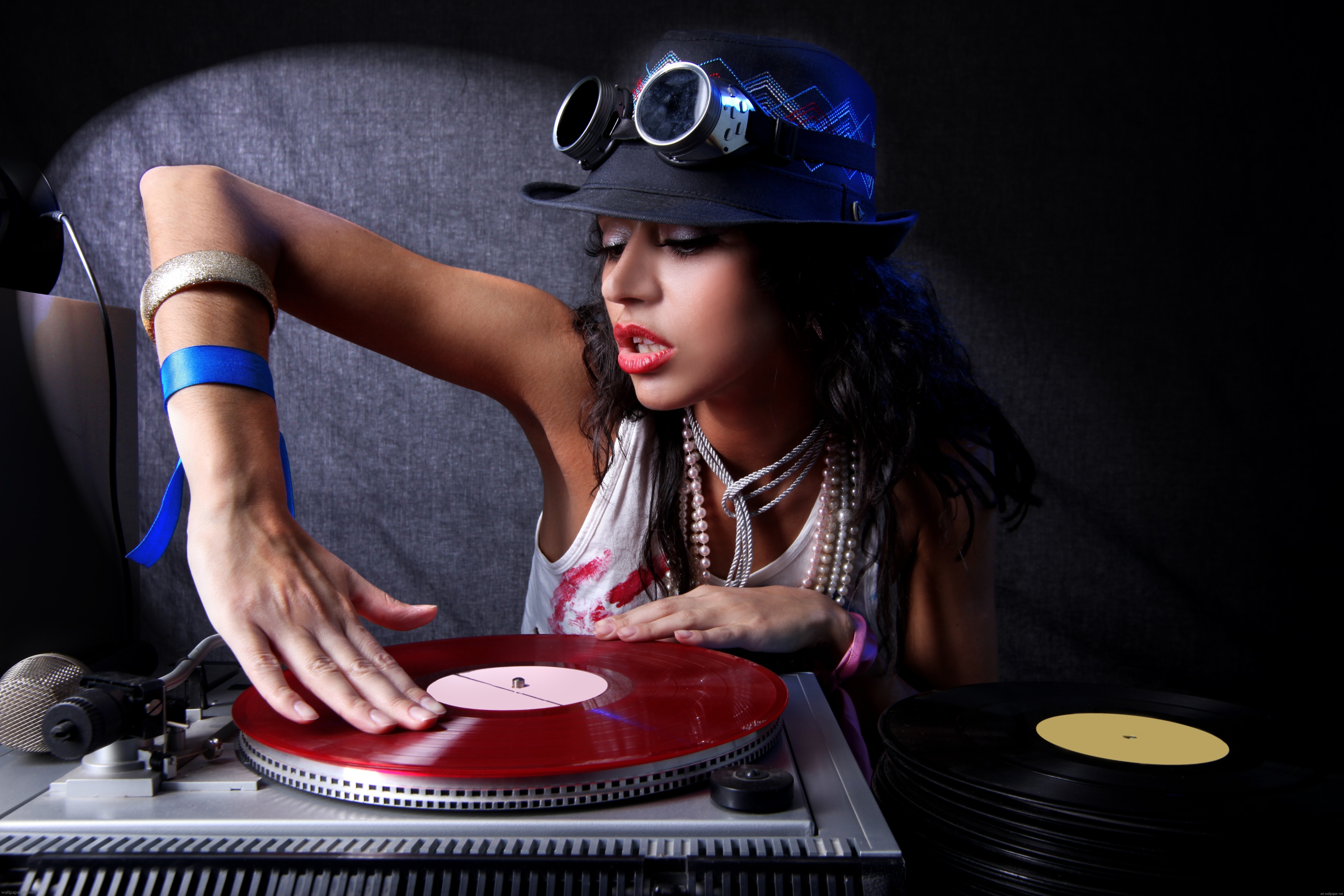 DJ girl with hat and goggles playing records HD Wallpaper