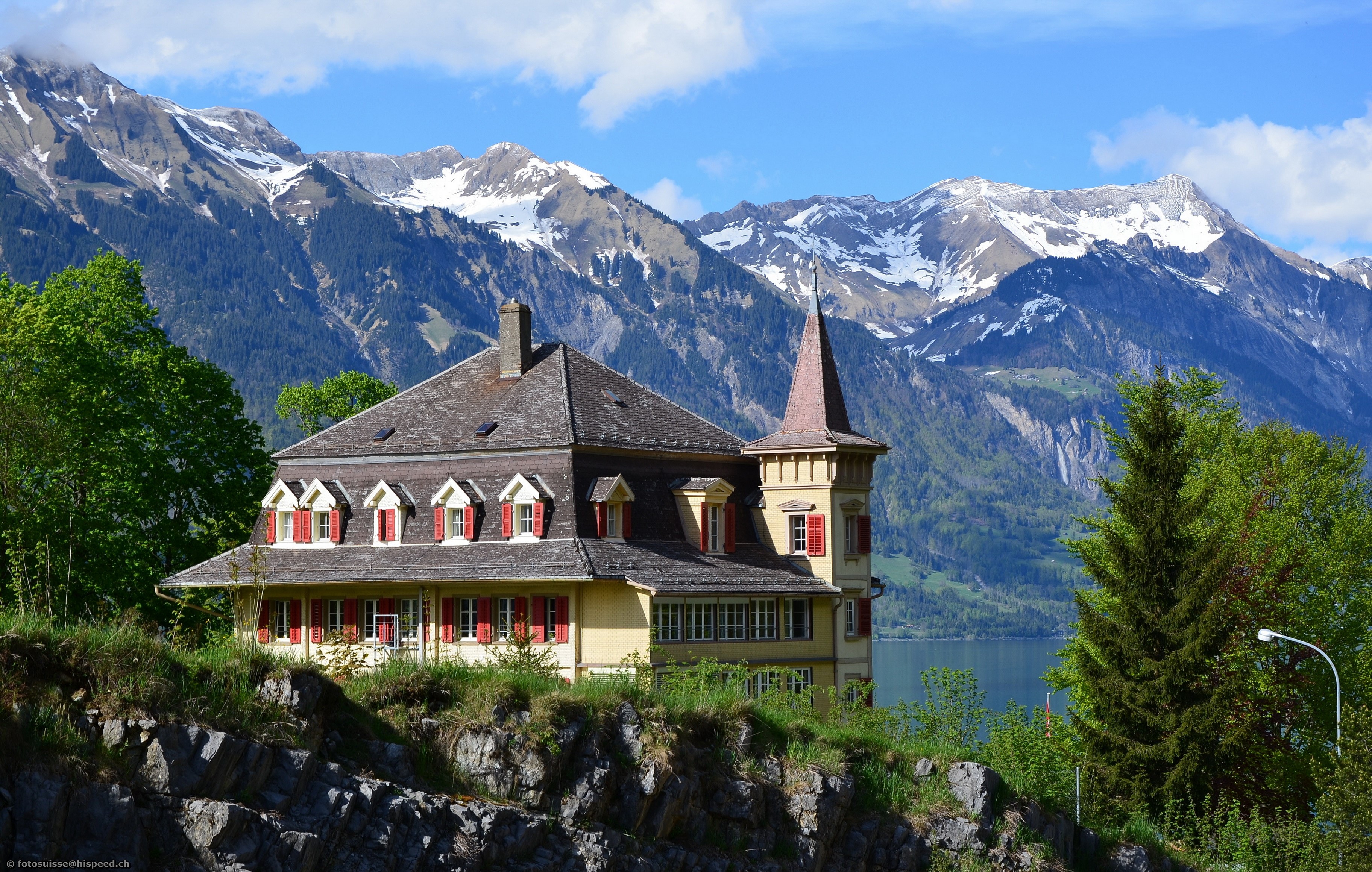 Yellow mansion with red shutters in Switzerland with mountains HD Wallpaper