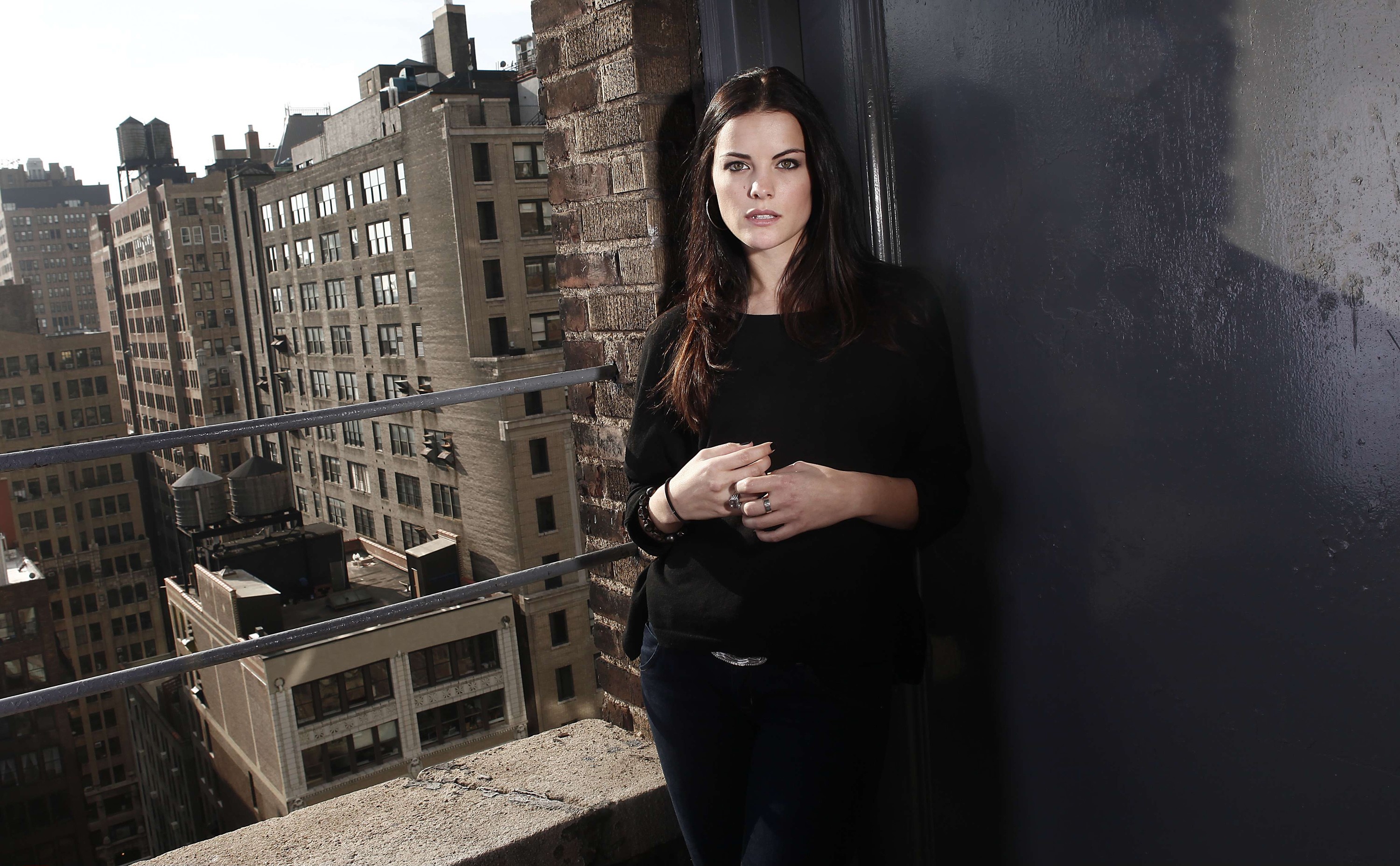 Jaimie Alexander leaning against a wall on a rooftop HD Wallpaper