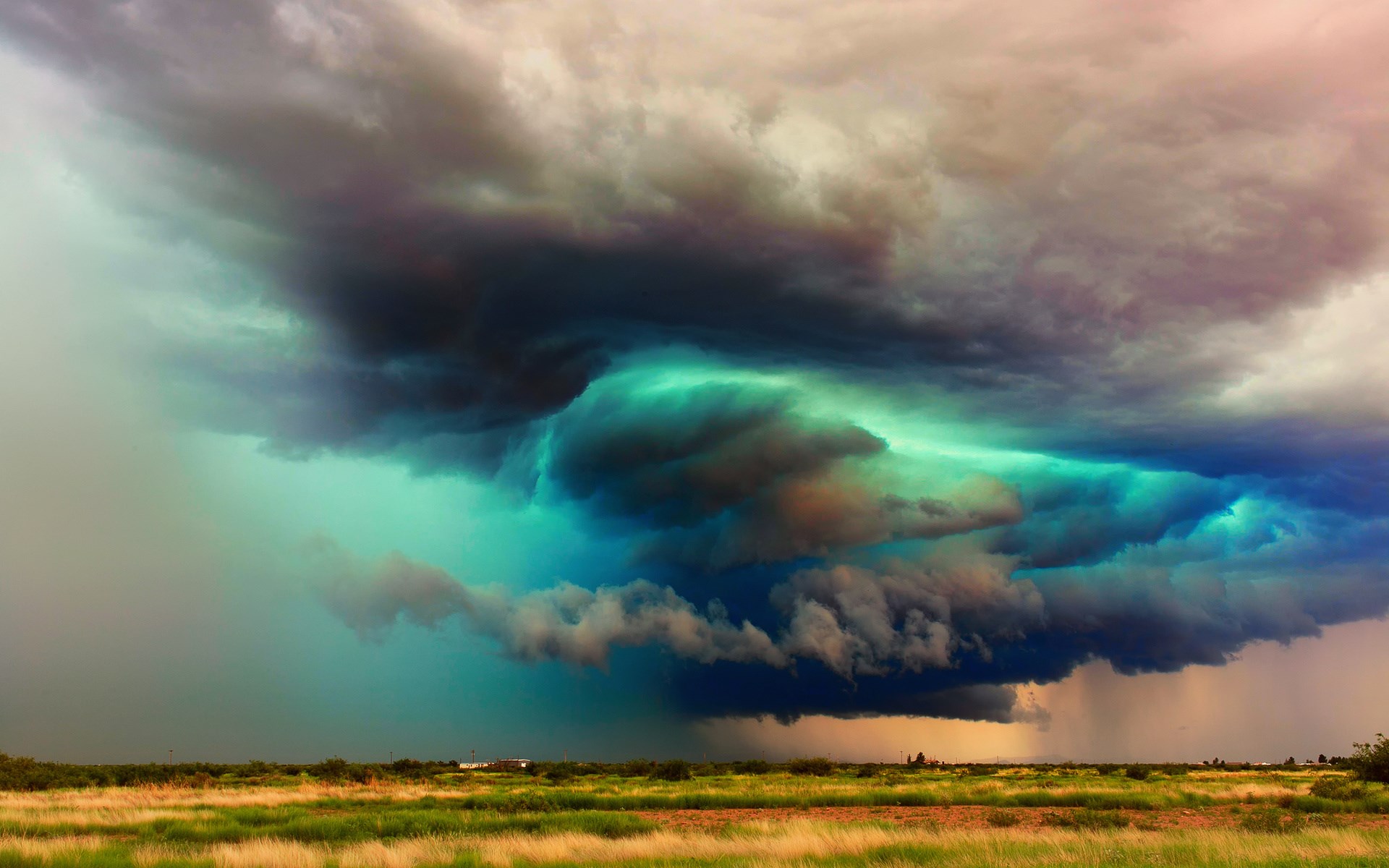 Storm clouds over a grassy field HD Wallpaper