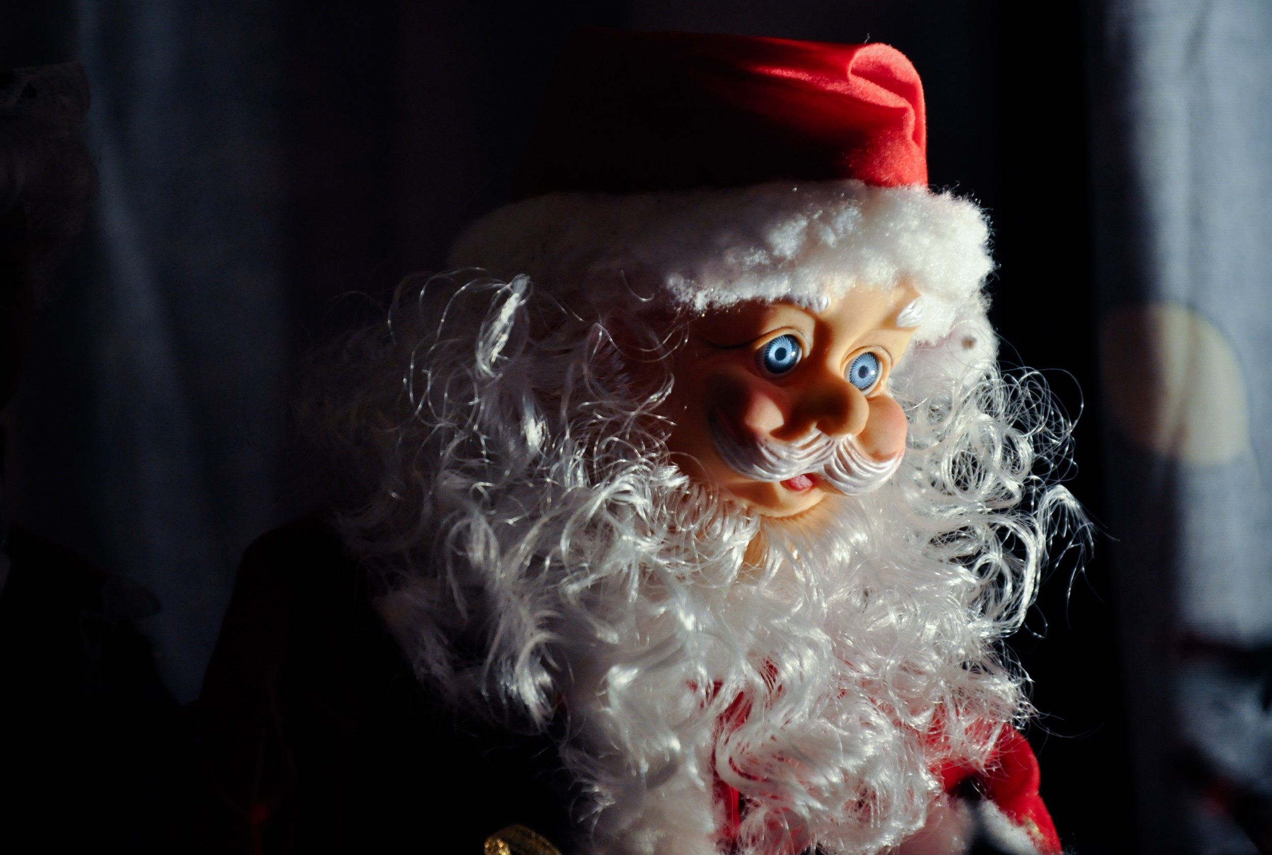 Close-up of a Santa Claus doll with blue eyes HD Wallpaper