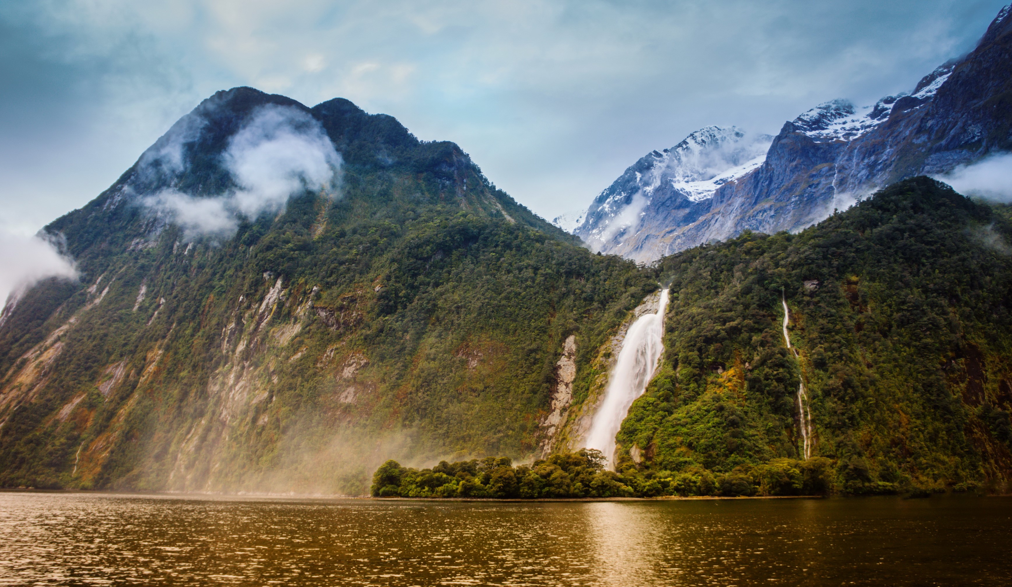 Waterfalls cascading down mountains in Fiordland National Park, New Zealand HD Wallpaper