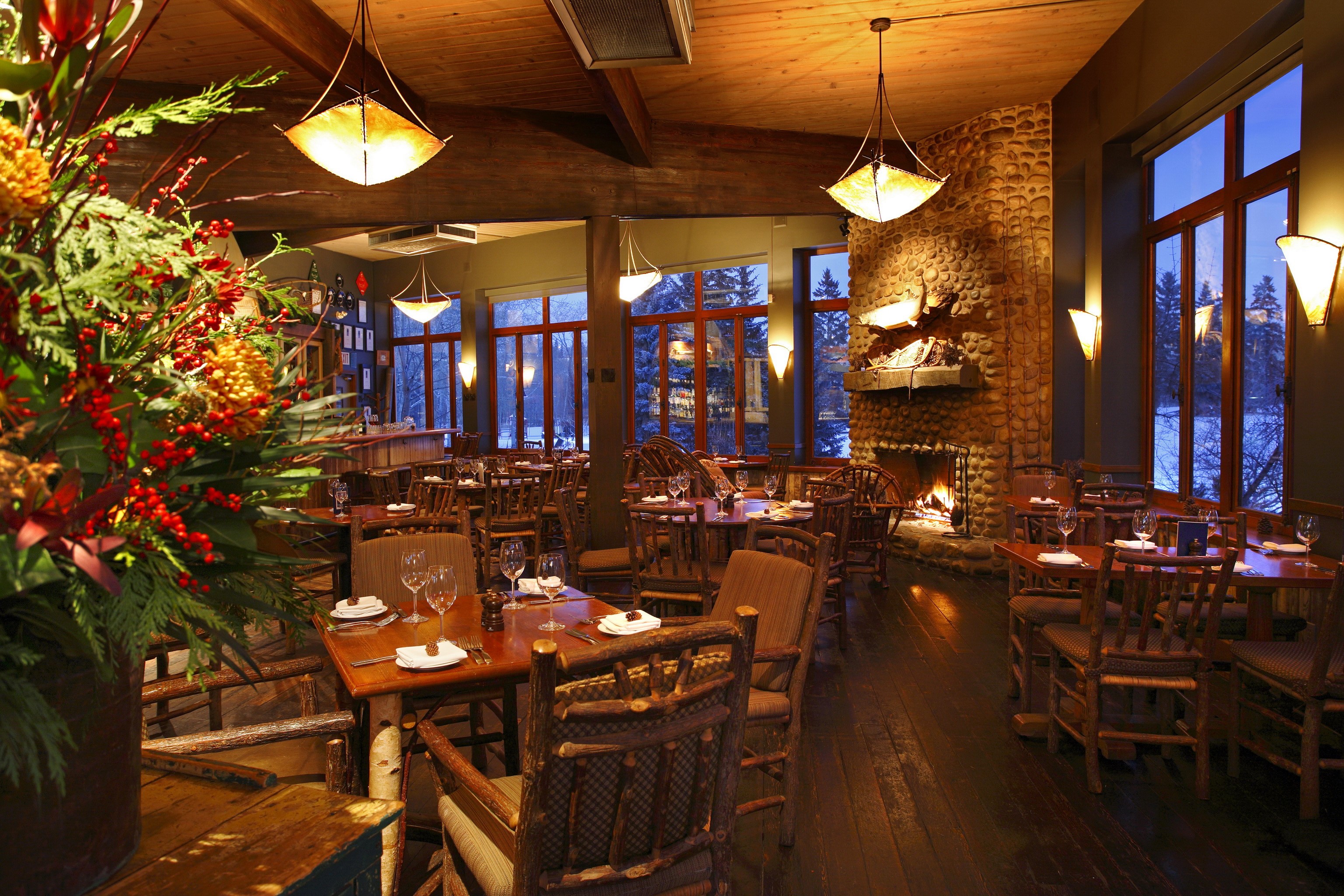 Cozy restaurant interior with fireplace and wooden furniture HD Wallpaper