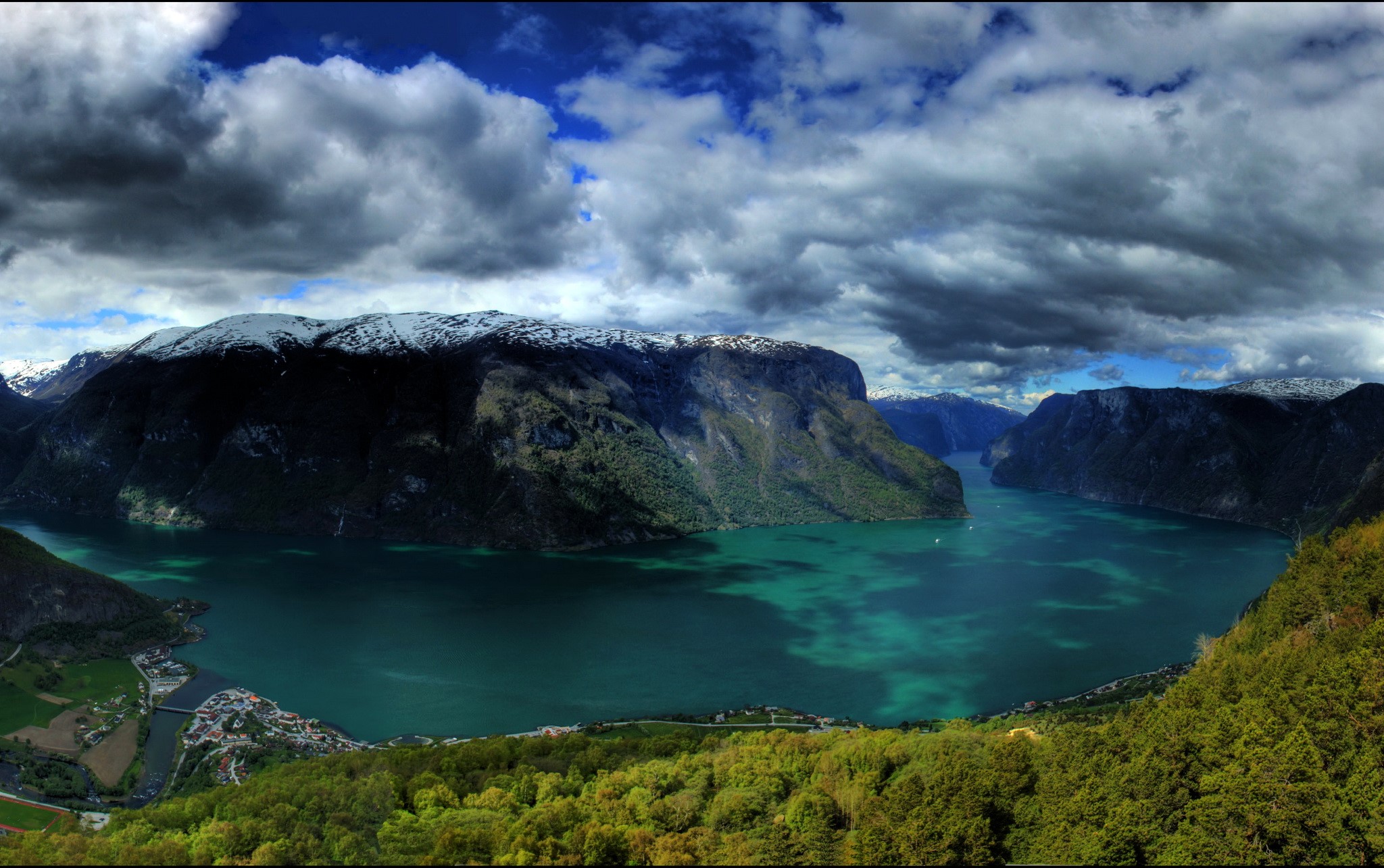 Fjord landscape with snow-capped mountains and clouds HD Wallpaper
