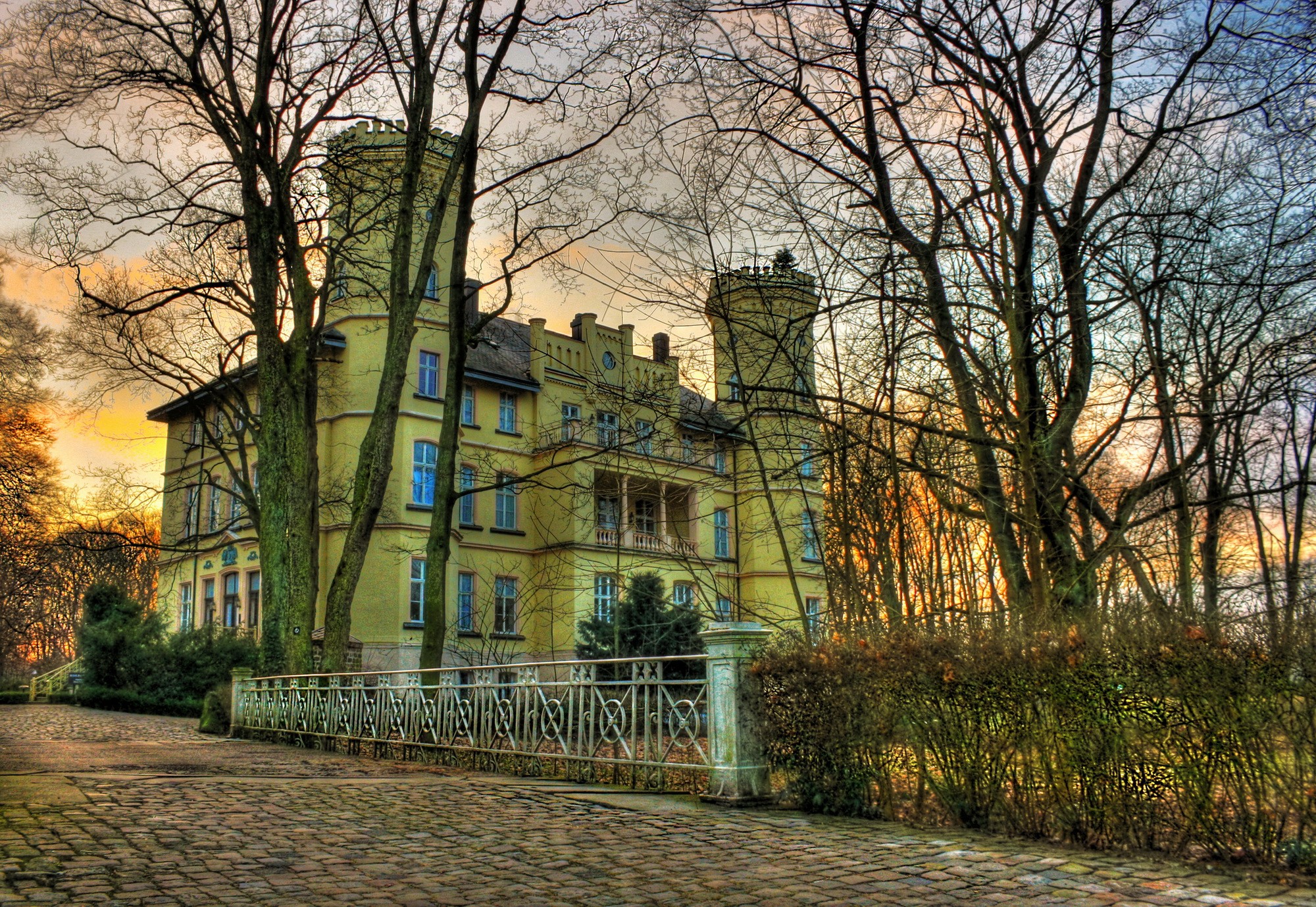 Yellow castle with towers surrounded by trees in Germany HD Wallpaper