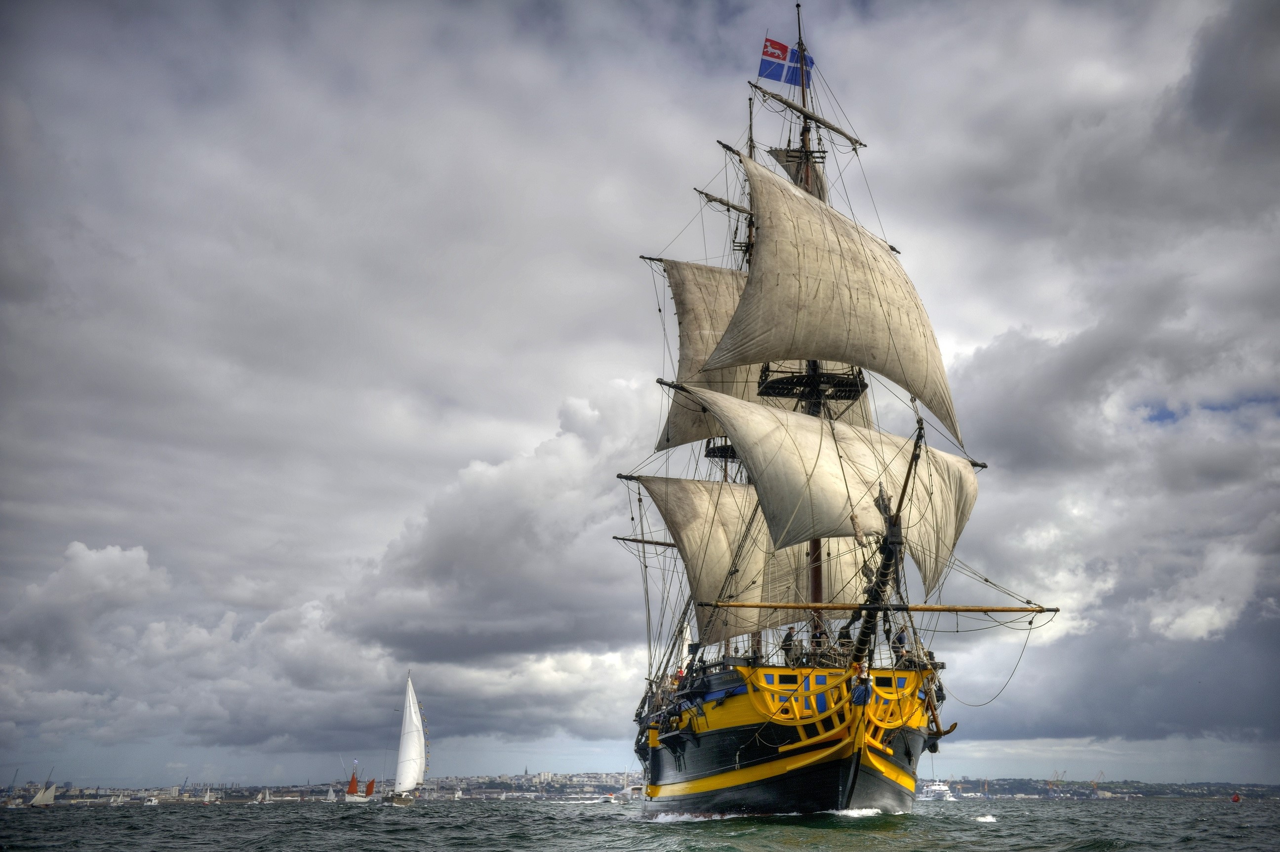 Tall ship sailing on the sea with other boats HD Wallpaper