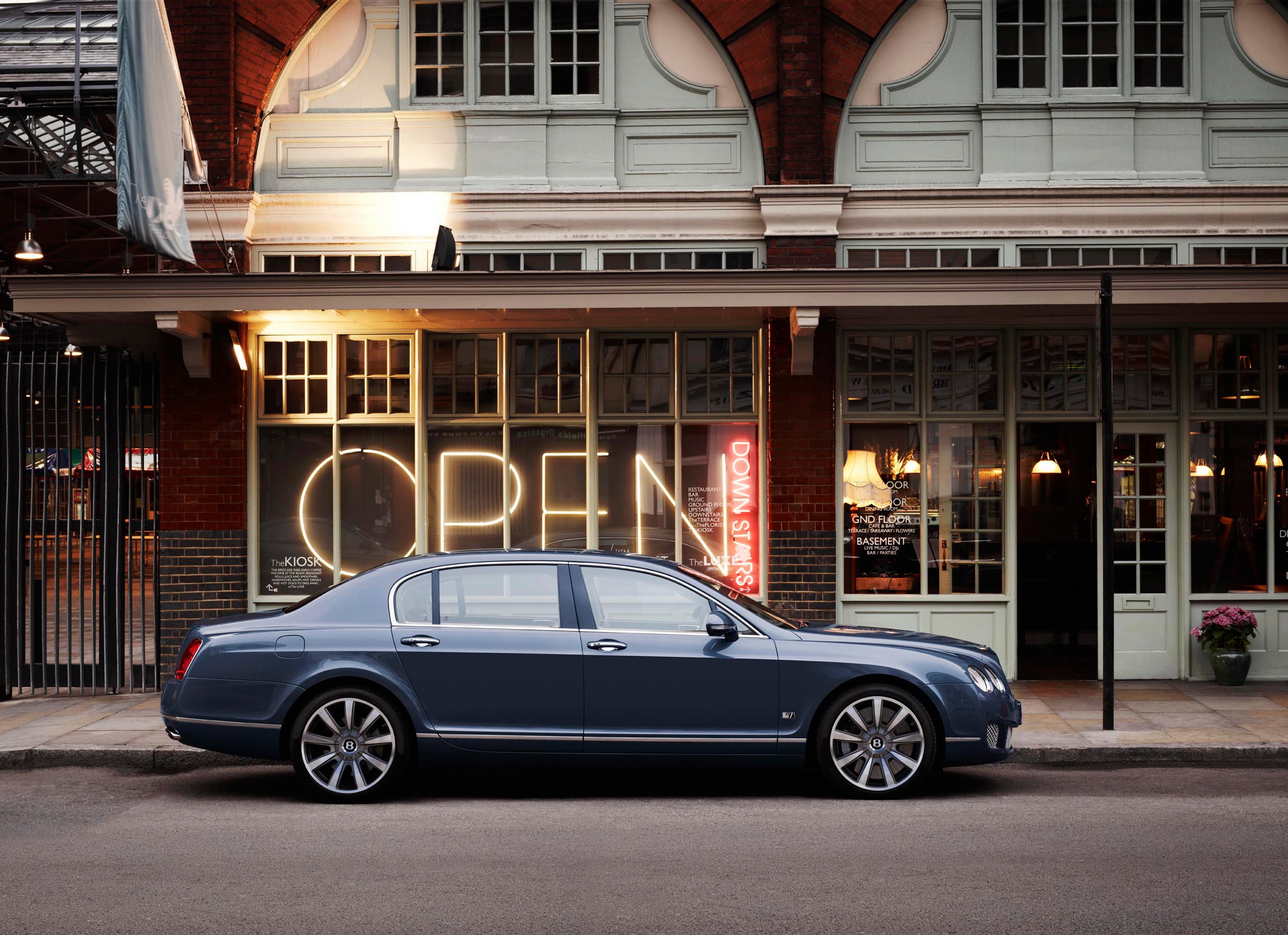 2011 Bentley Continental Flying Spur Series parked outside building HD Wallpaper