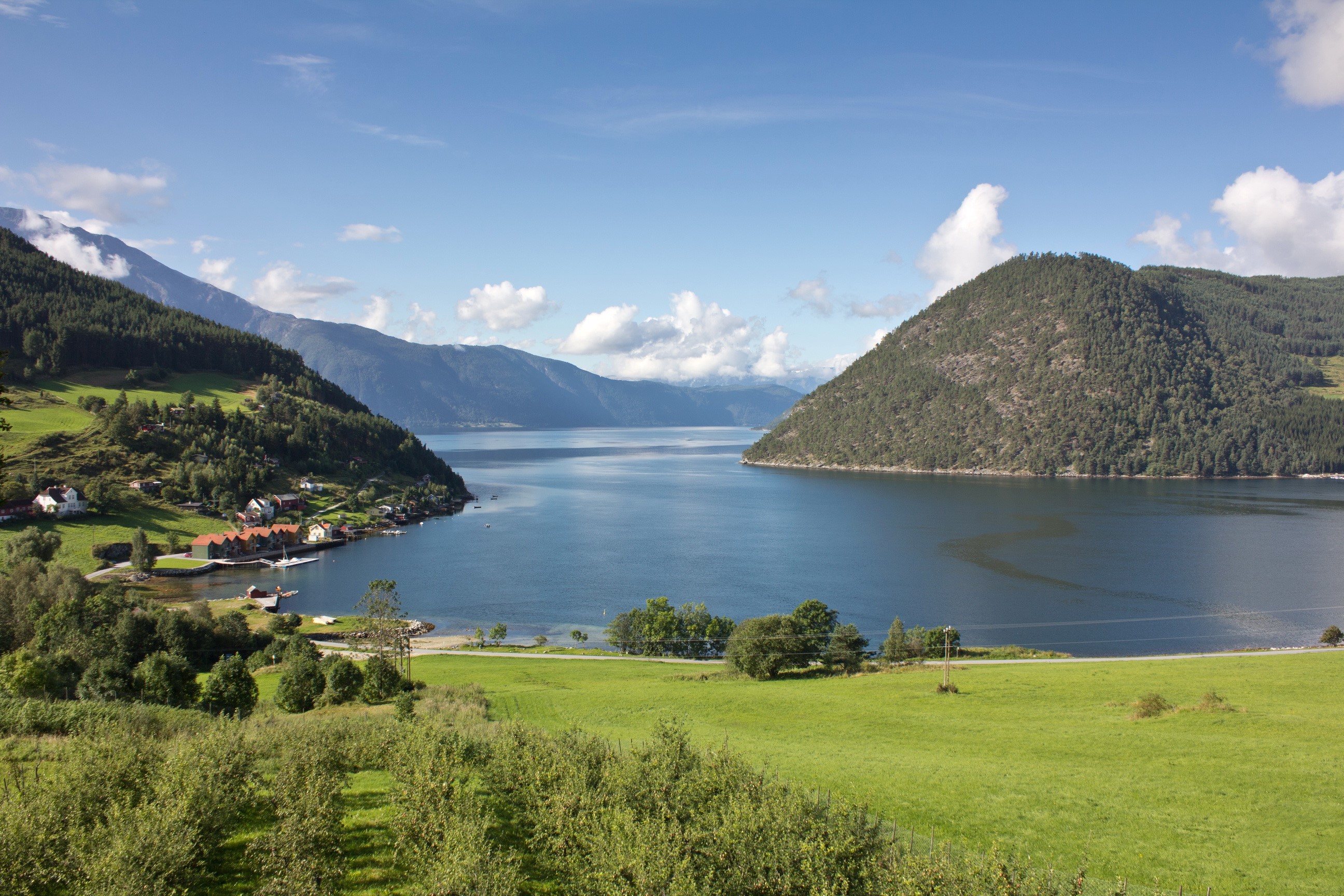 View of a fjord in Norway with mountains and a village HD Wallpaper