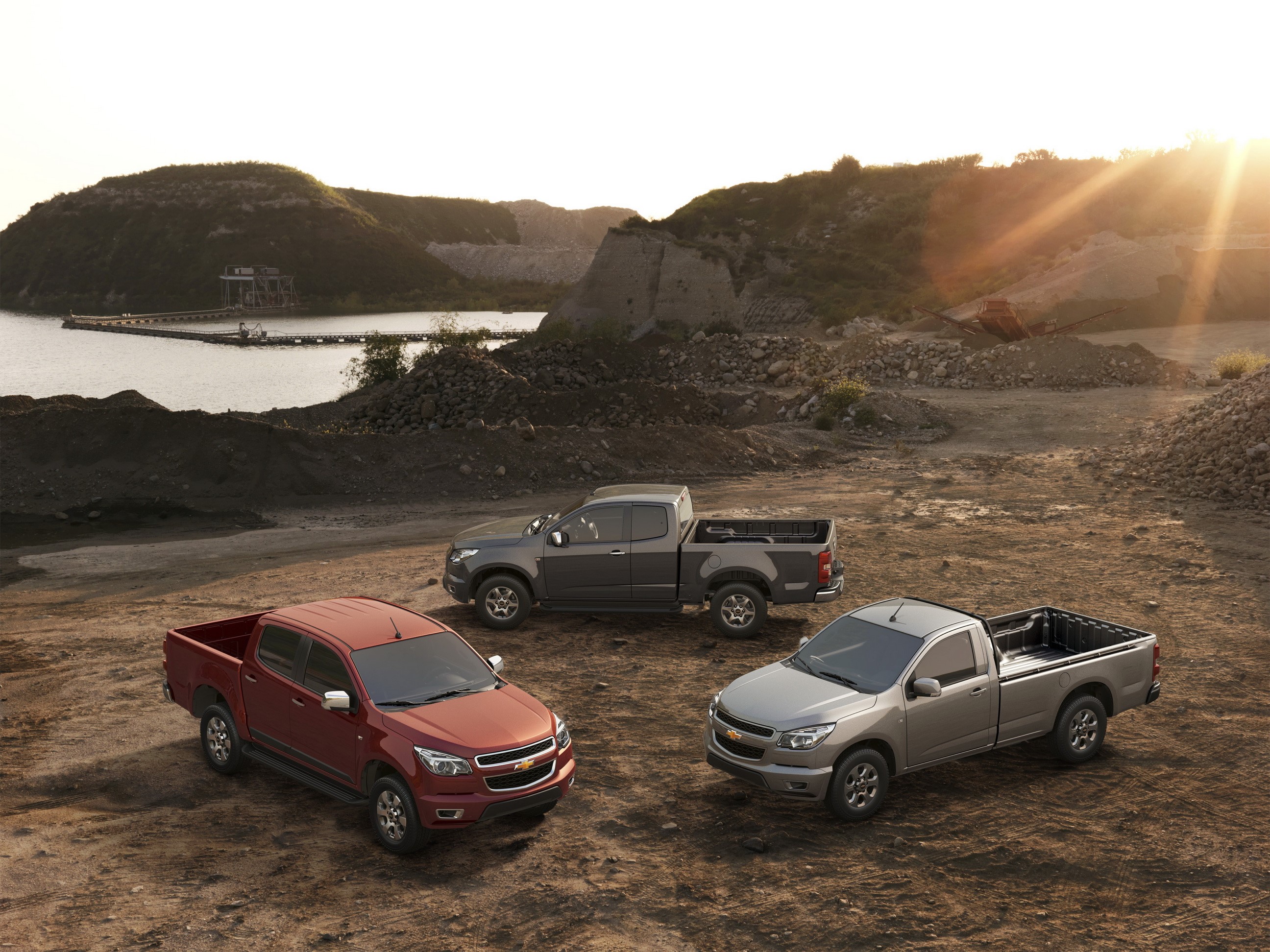 Three Chevrolet Colorado trucks at a quarry HD Wallpaper