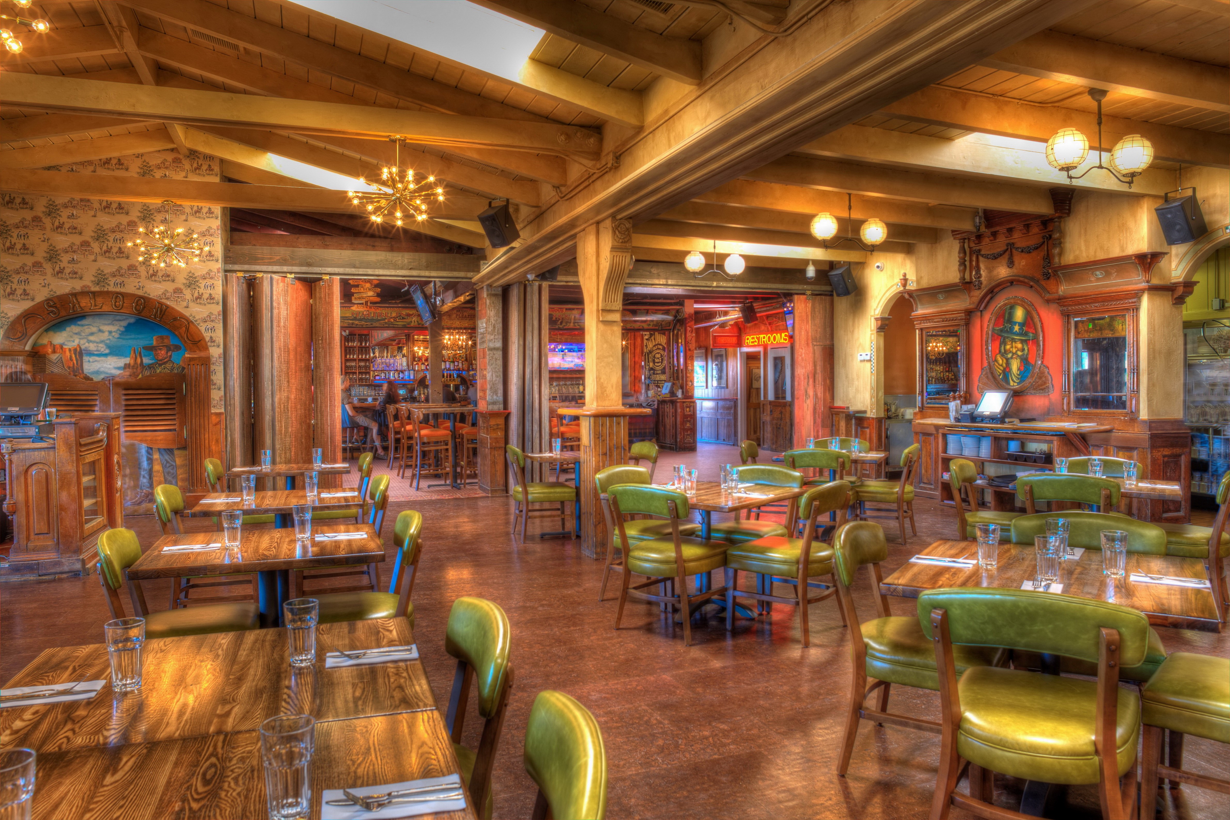 Interior of a wooden saloon with tables and chairs HD Wallpaper