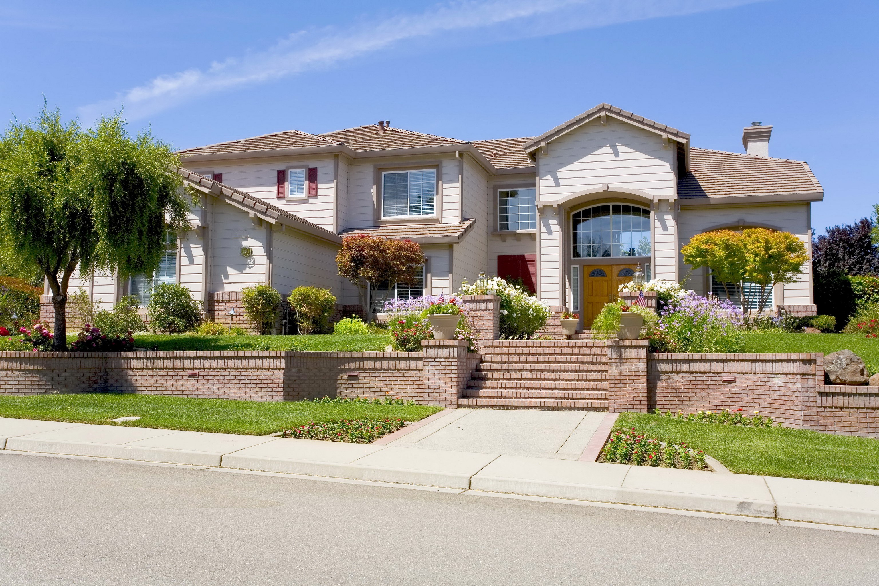 Large suburban house with landscaping and brick accents HD Wallpaper