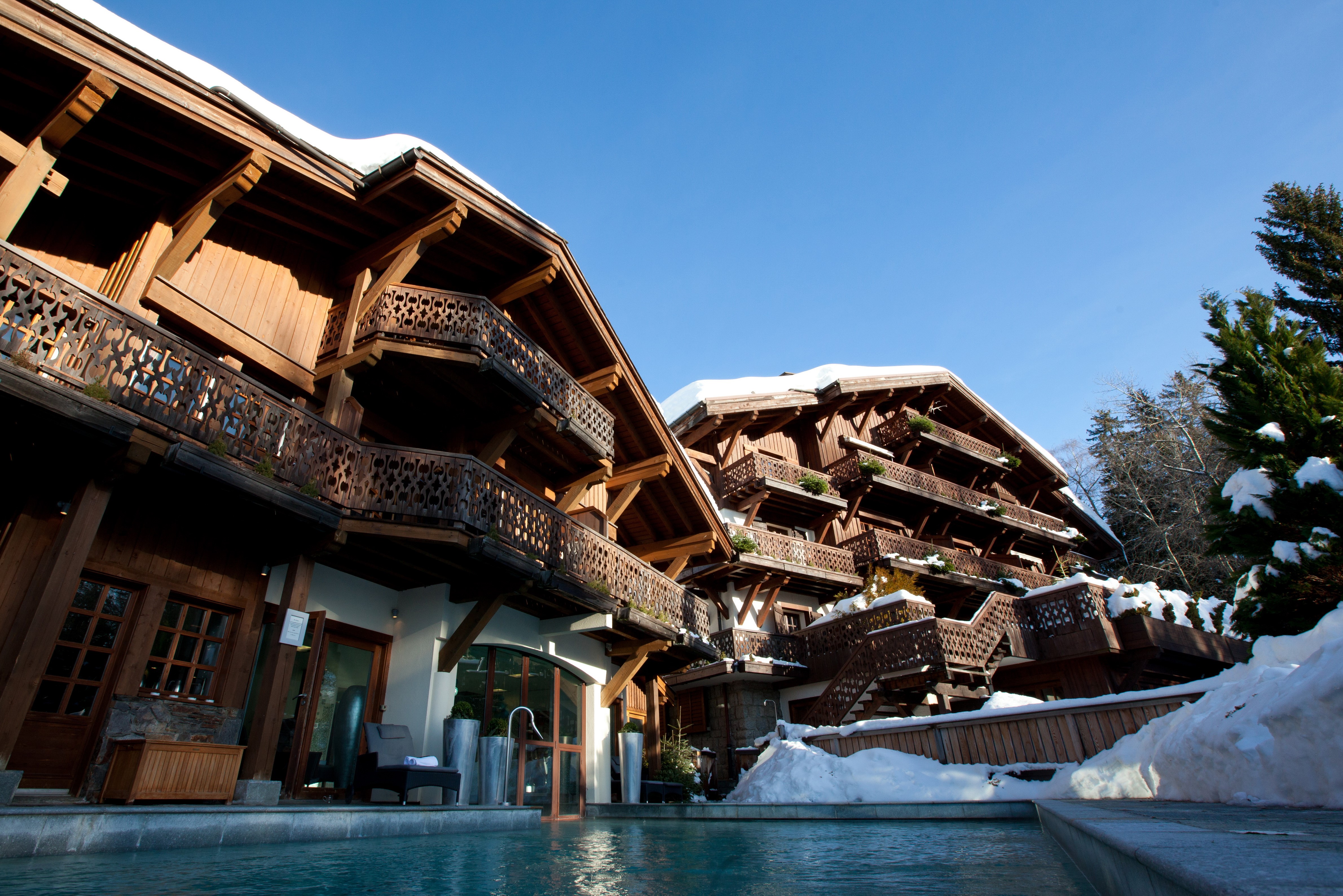 Wooden chalets in Courchevel, France with snow HD Wallpaper
