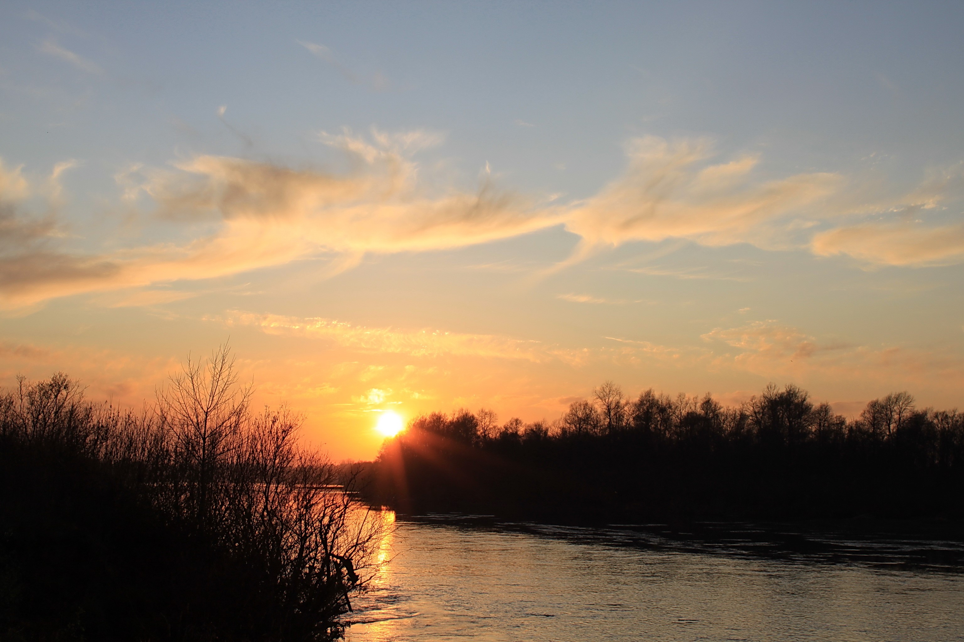 Sunset over a river with trees and clouds HD Wallpaper