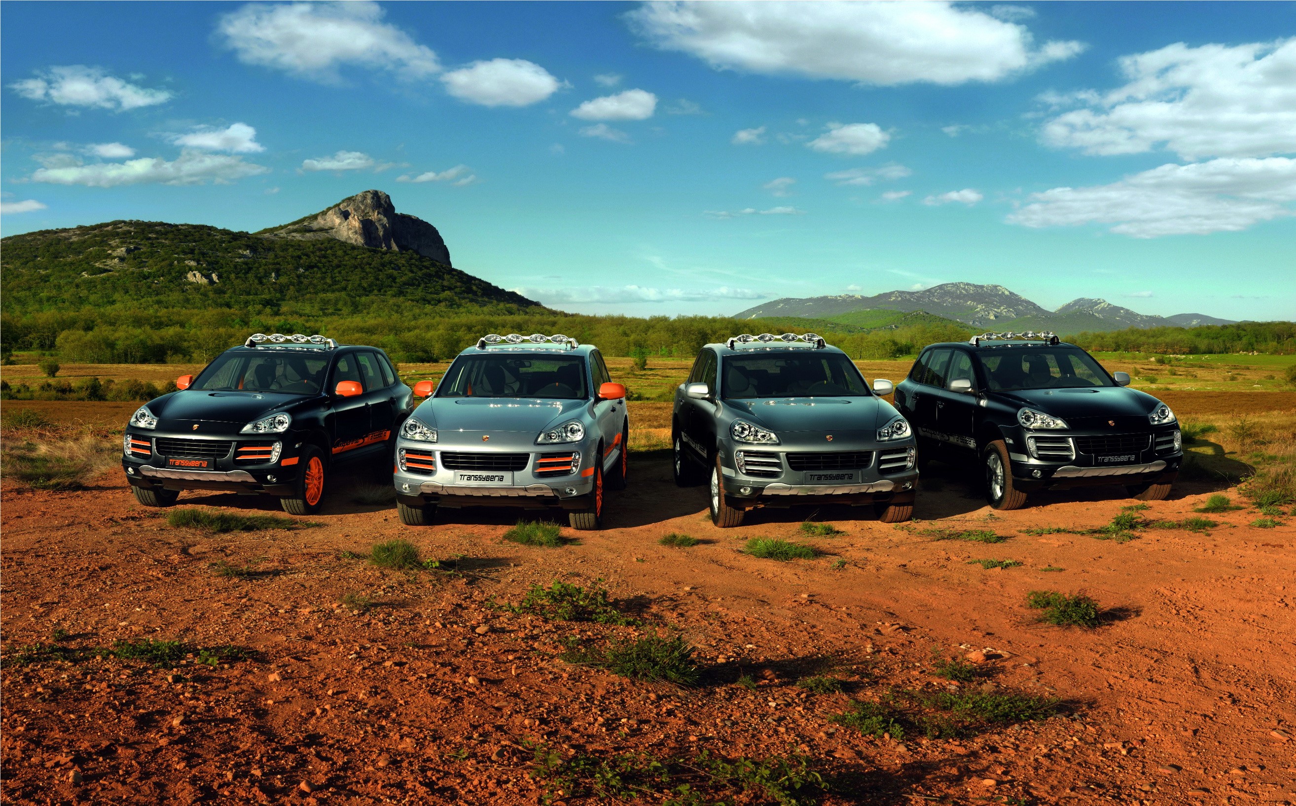 Four Porsche Cayenne S Transsyberia SUVs in a landscape HD Wallpaper