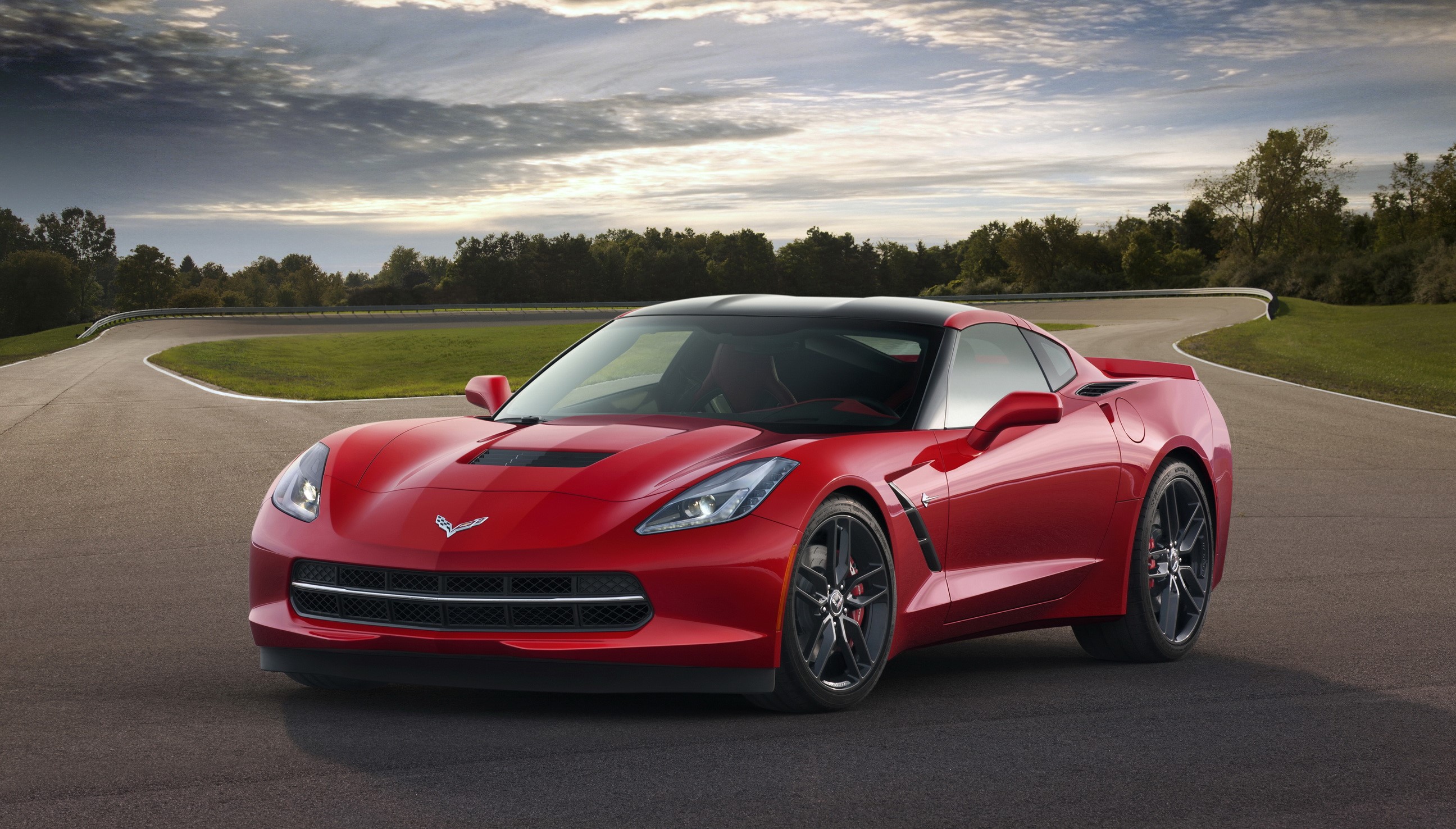 Red 2014 Chevrolet Corvette Stingray on a Racetrack HD Wallpaper