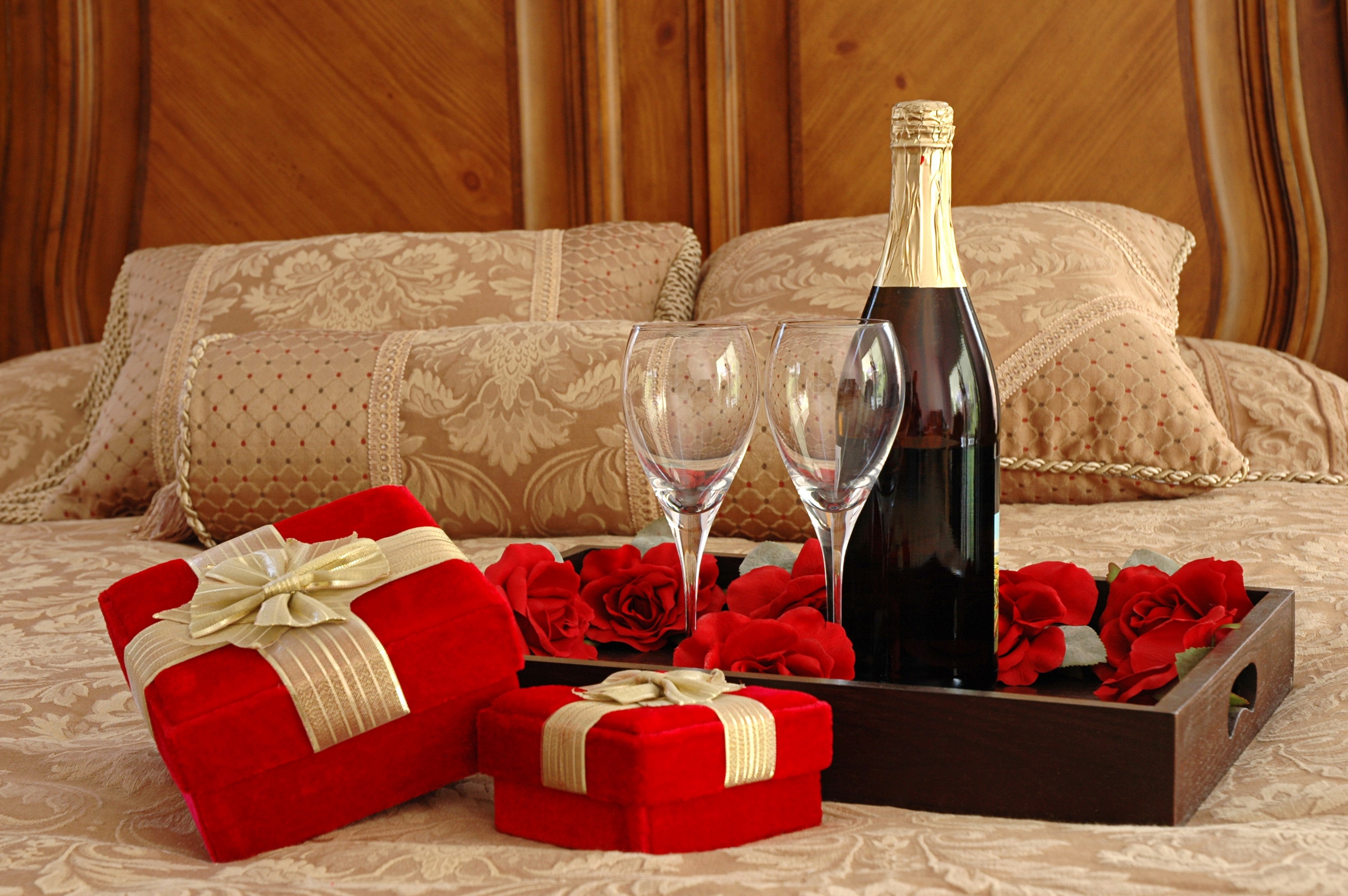 Champagne, Gifts, and Roses on a Bed HD Wallpaper