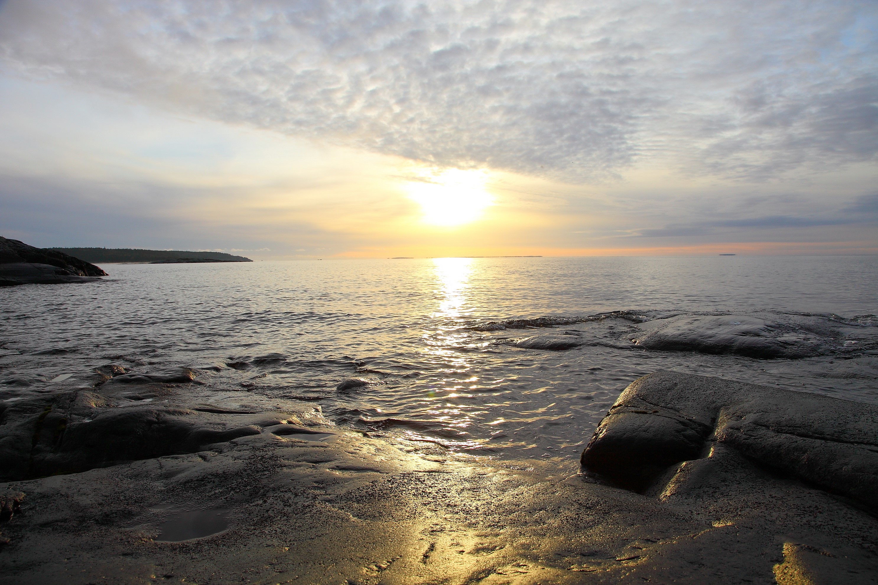 Sunset over the sea with rocky shore HD Wallpaper