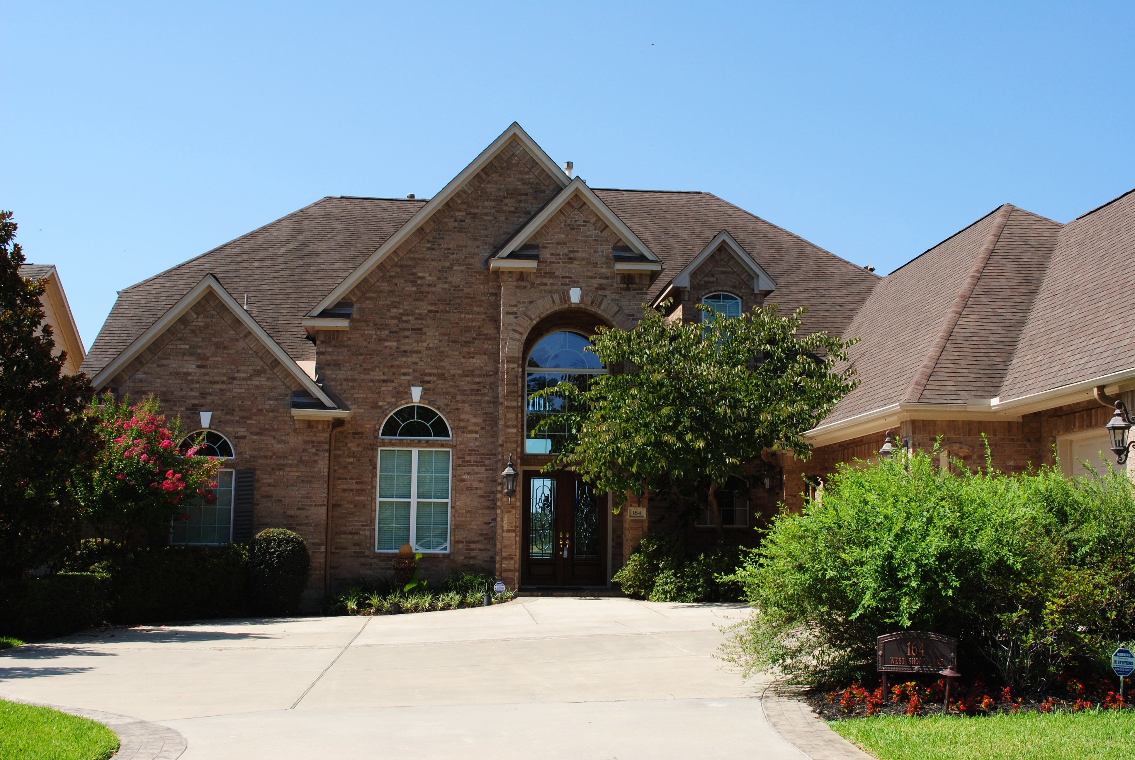 Brick Mansion with Driveway and Landscaping HD Wallpaper
