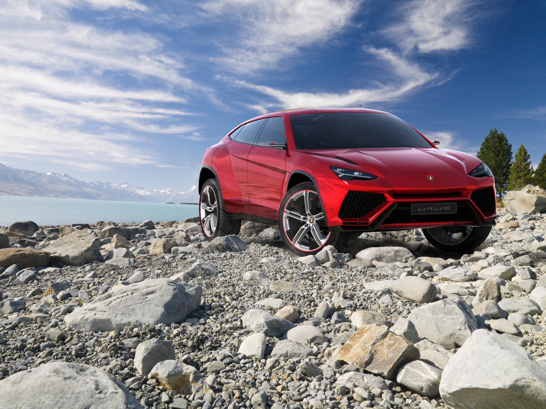 Red Lamborghini Urus on Rocky Shore HD Wallpaper