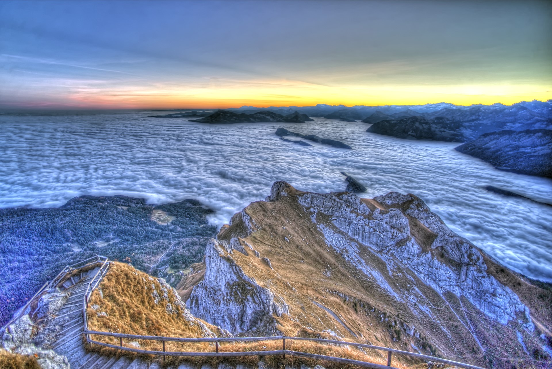 Mountain peak above clouds at sunrise with wooden stairs HD Wallpaper