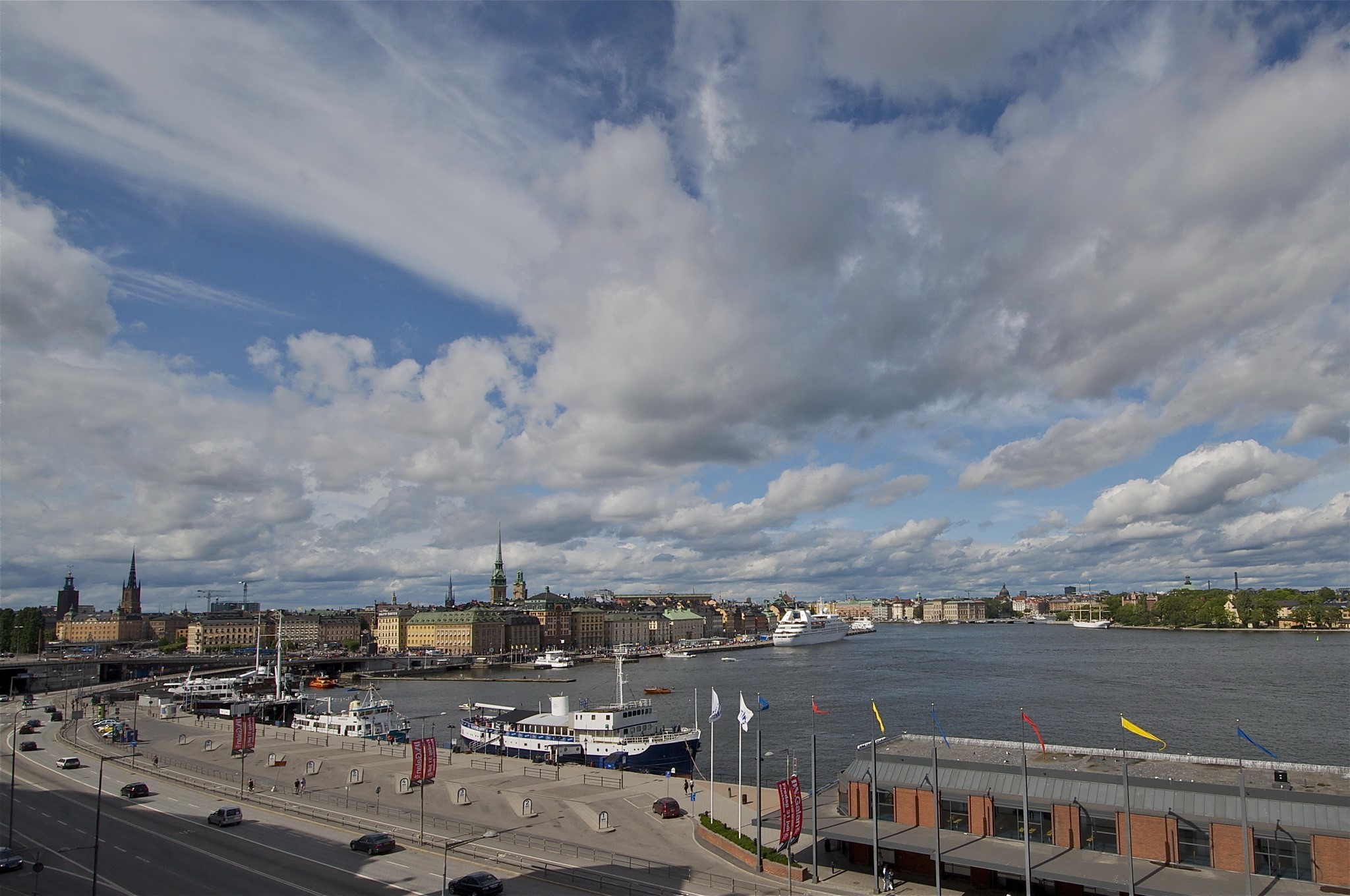 Stockholm cityscape with boats and clouds HD Wallpaper