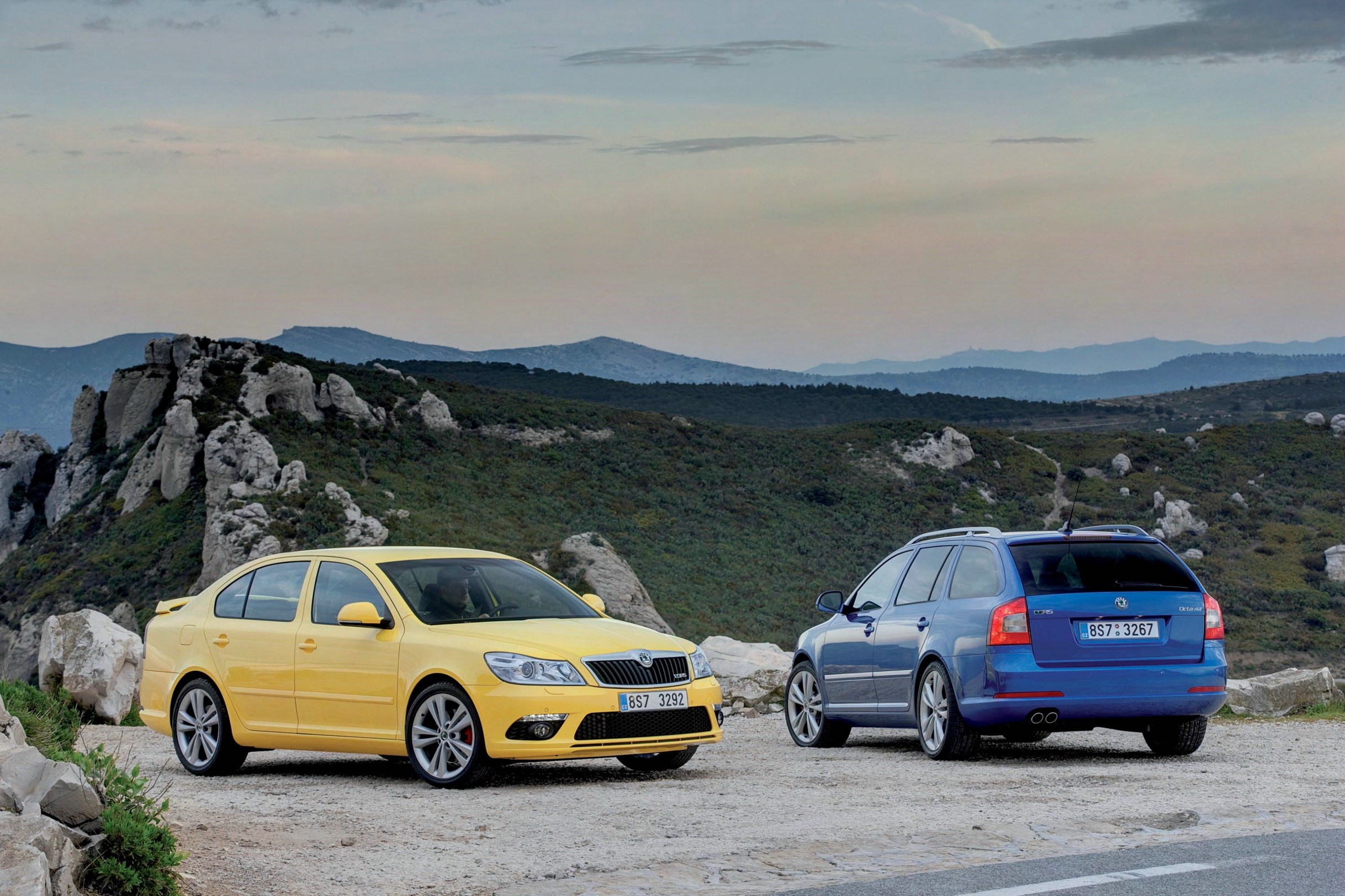 Yellow and Blue Skoda Octavia RS Cars on Mountain Road HD Wallpaper