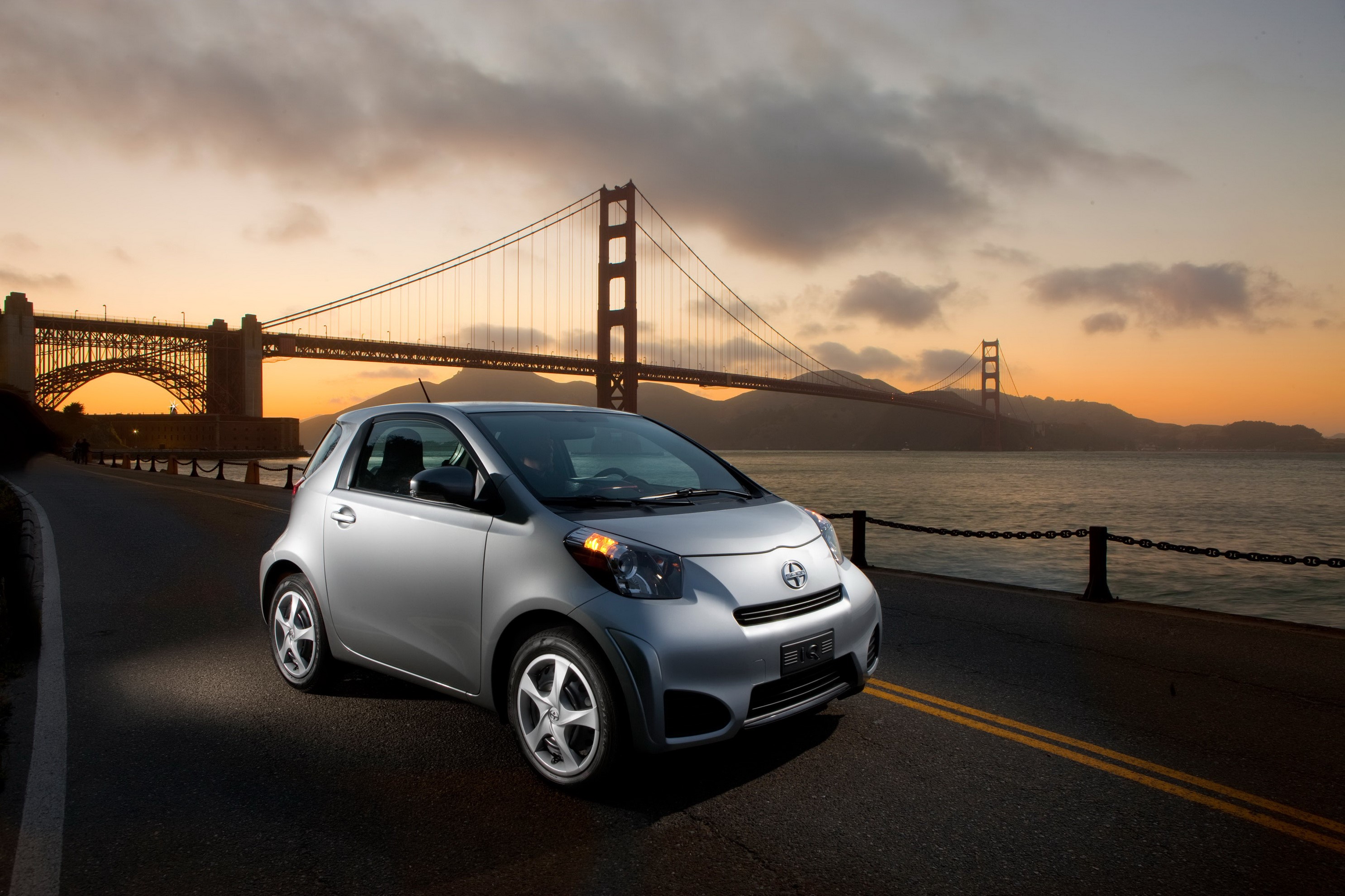 2012 Scion iQ on road near Golden Gate Bridge HD Wallpaper